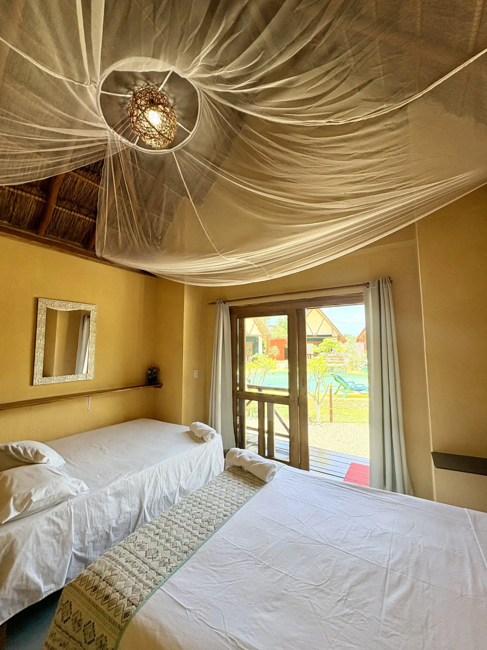 Tropical bedroom with mosquito net canopy