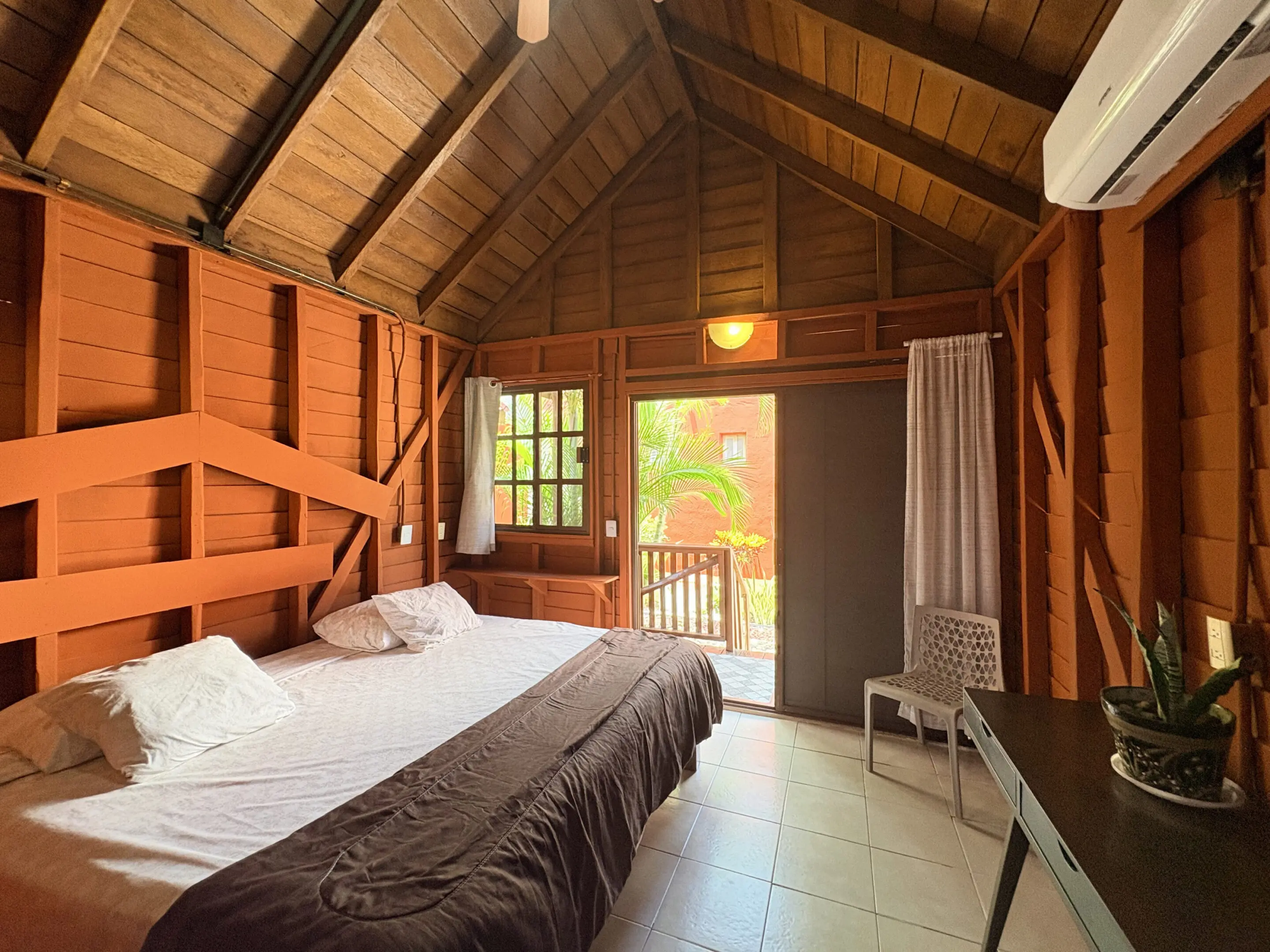 Rustic wooden cabin bedroom with balcony