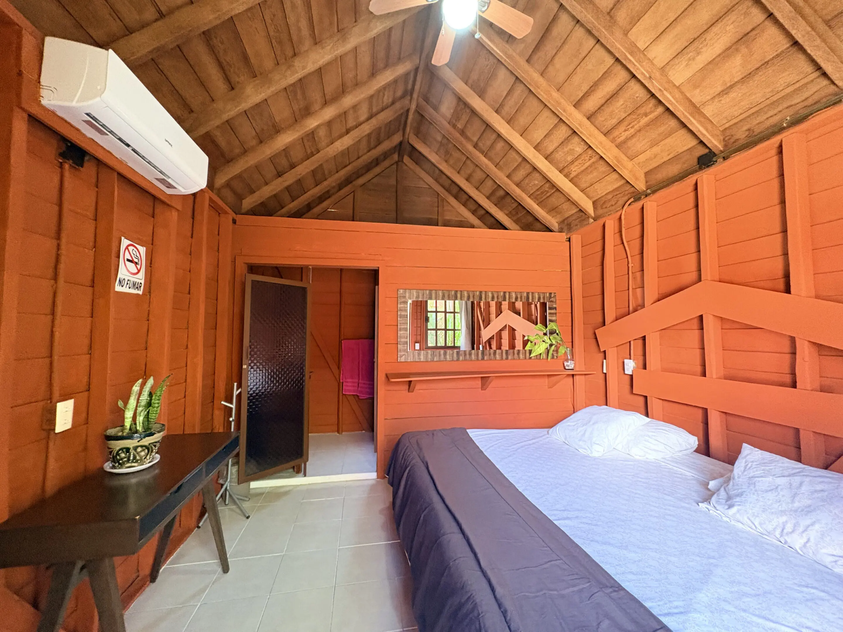 Cozy rustic bedroom with vaulted wooden ceiling