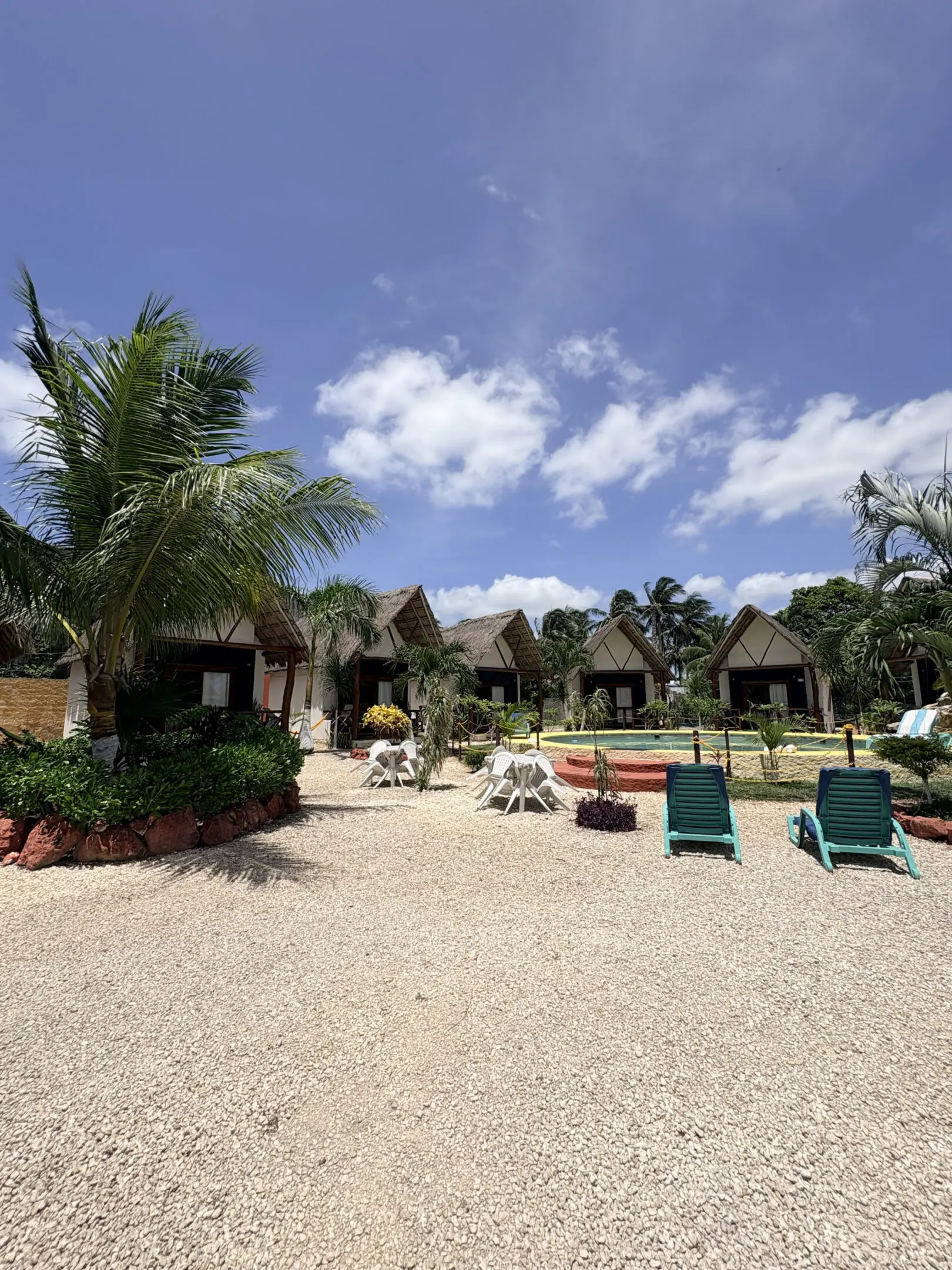 Tropical resort bungalows with lounge chairs