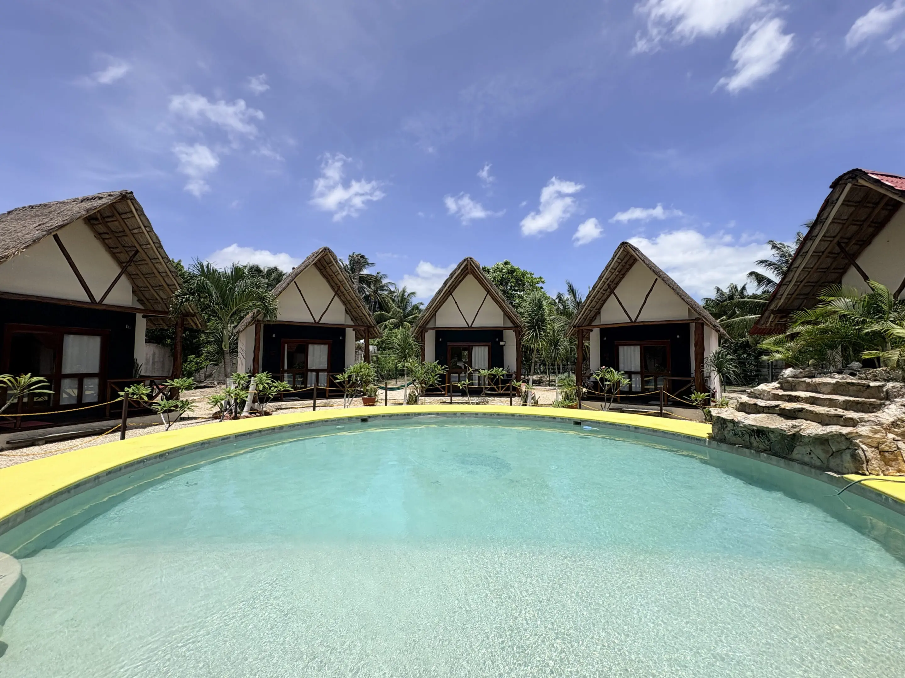 Tropical resort bungalows by swimming pool