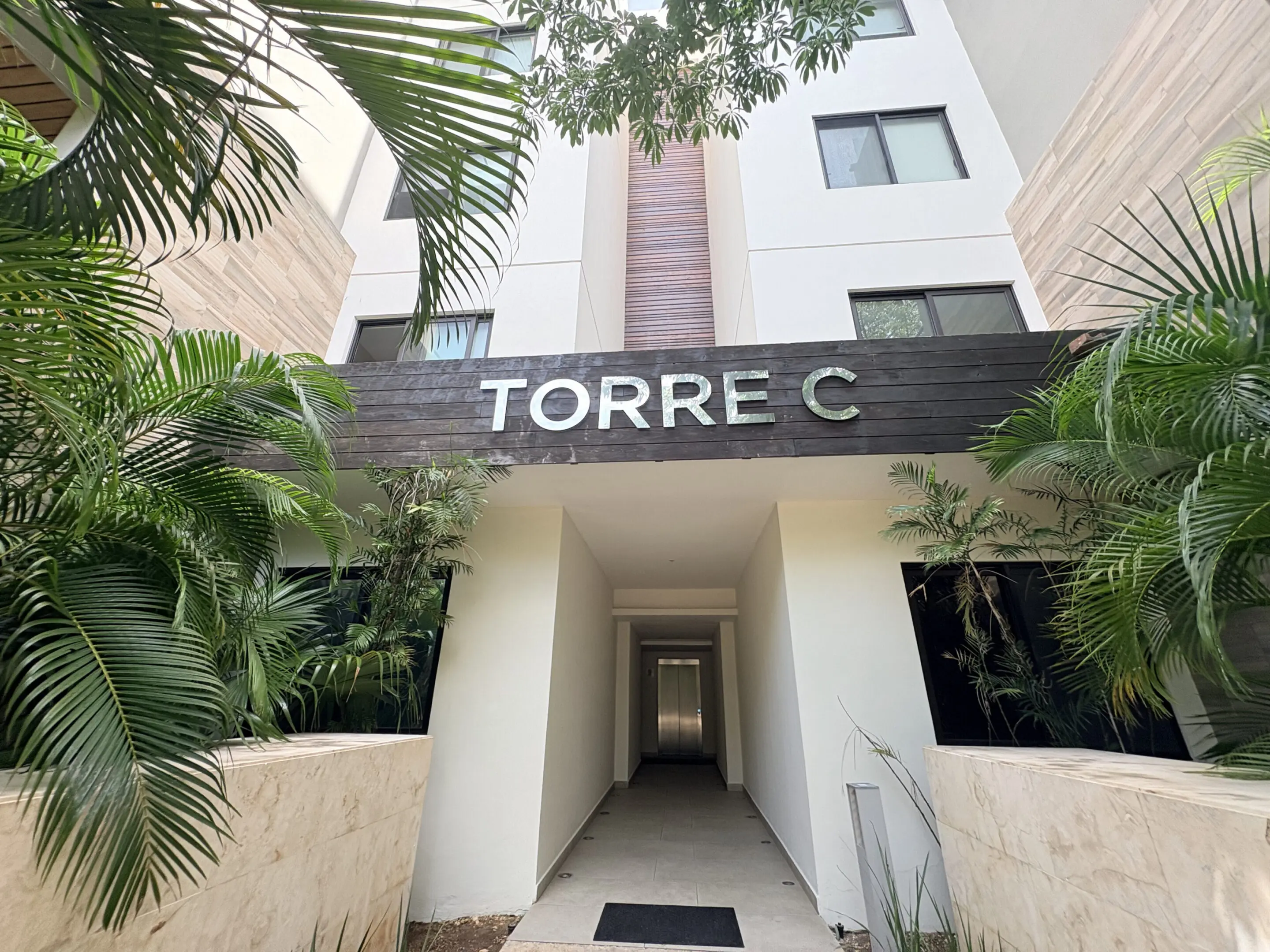 Apartment tower entrance labeled TORRE C