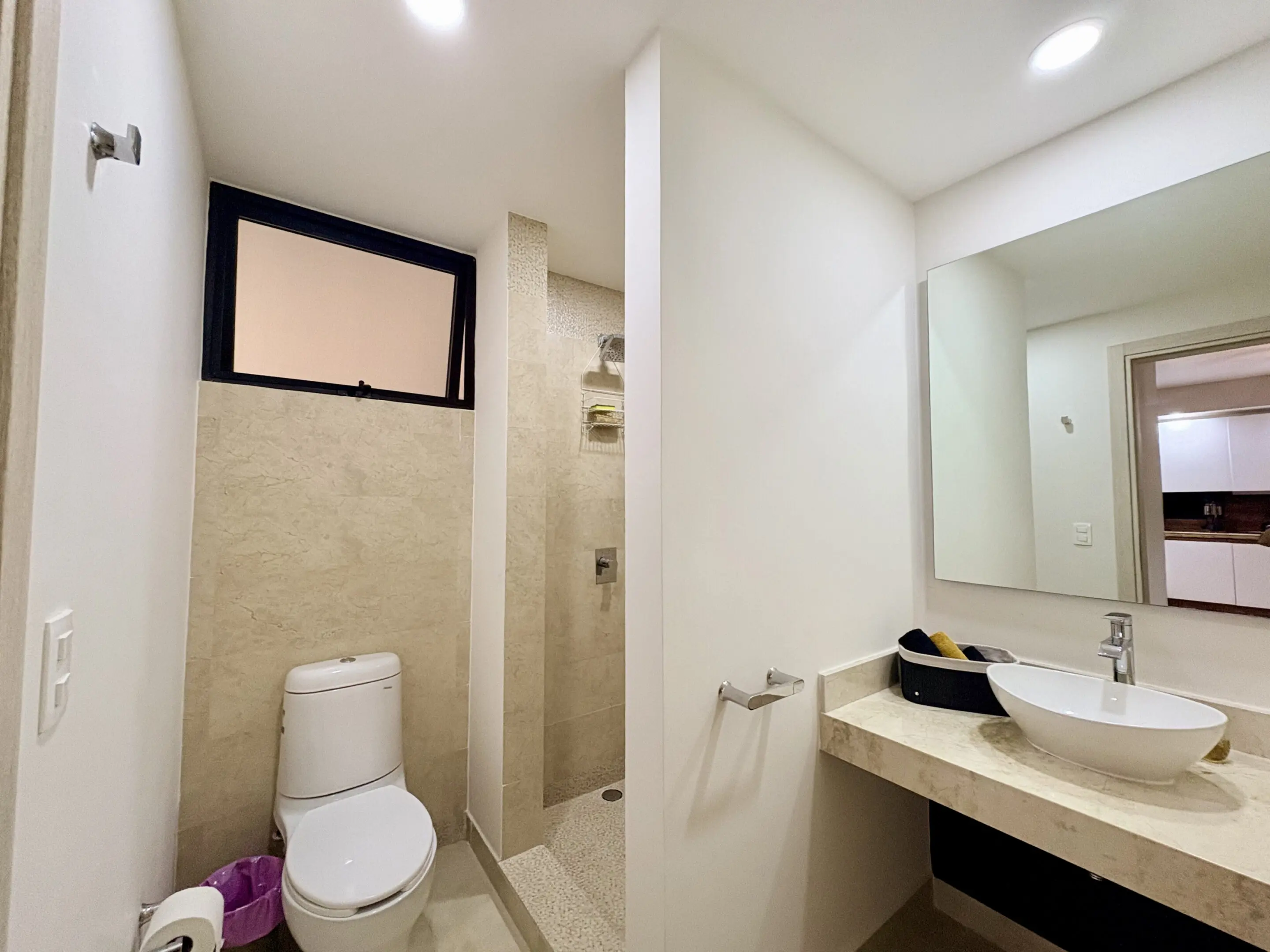 Modern bathroom with toilet, shower, vessel sink
