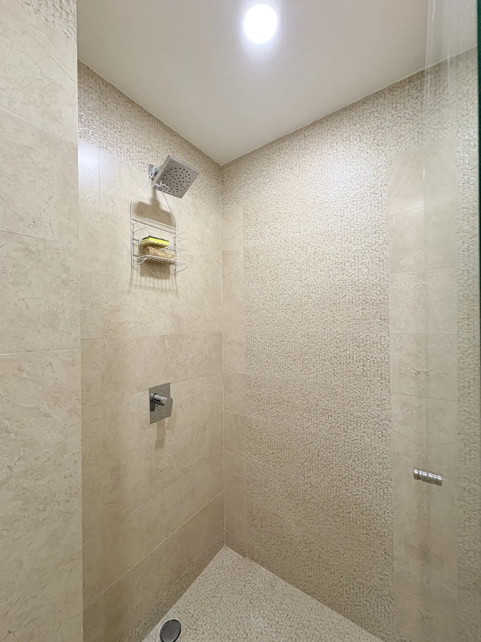 Beige tiled walk-in shower with rain showerhead