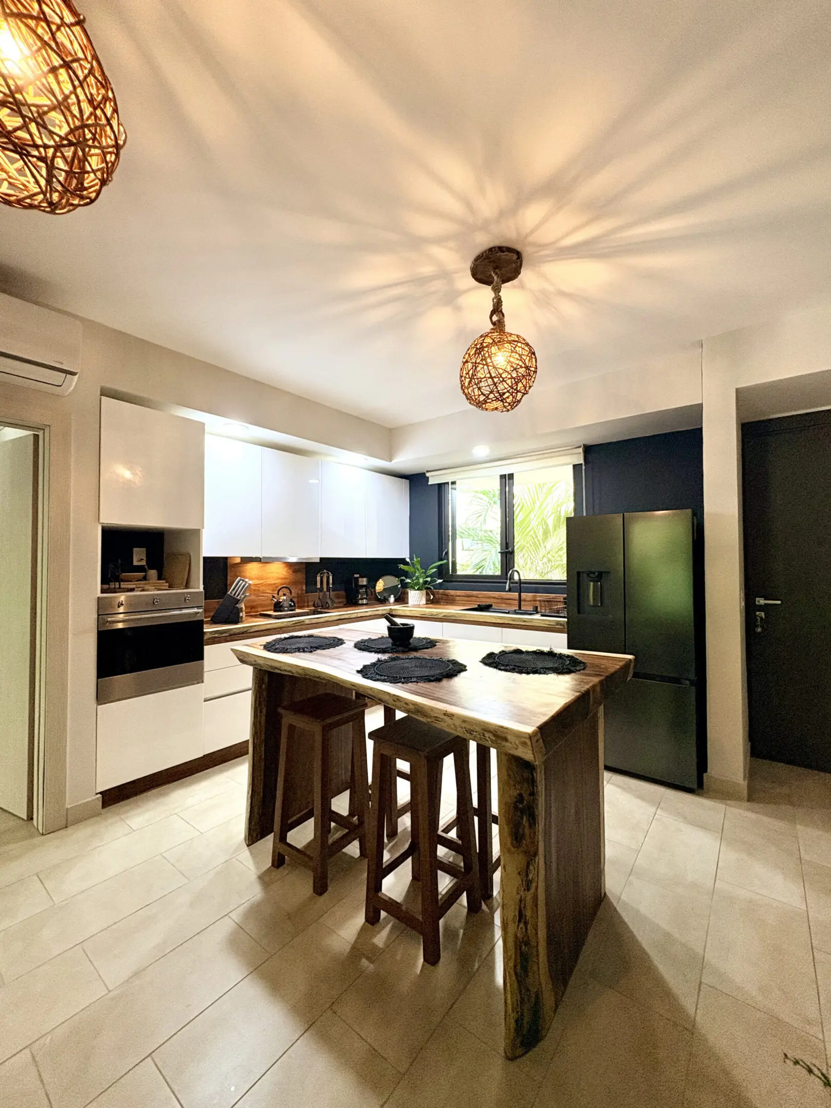 Modern kitchen with wooden island and pendant lights