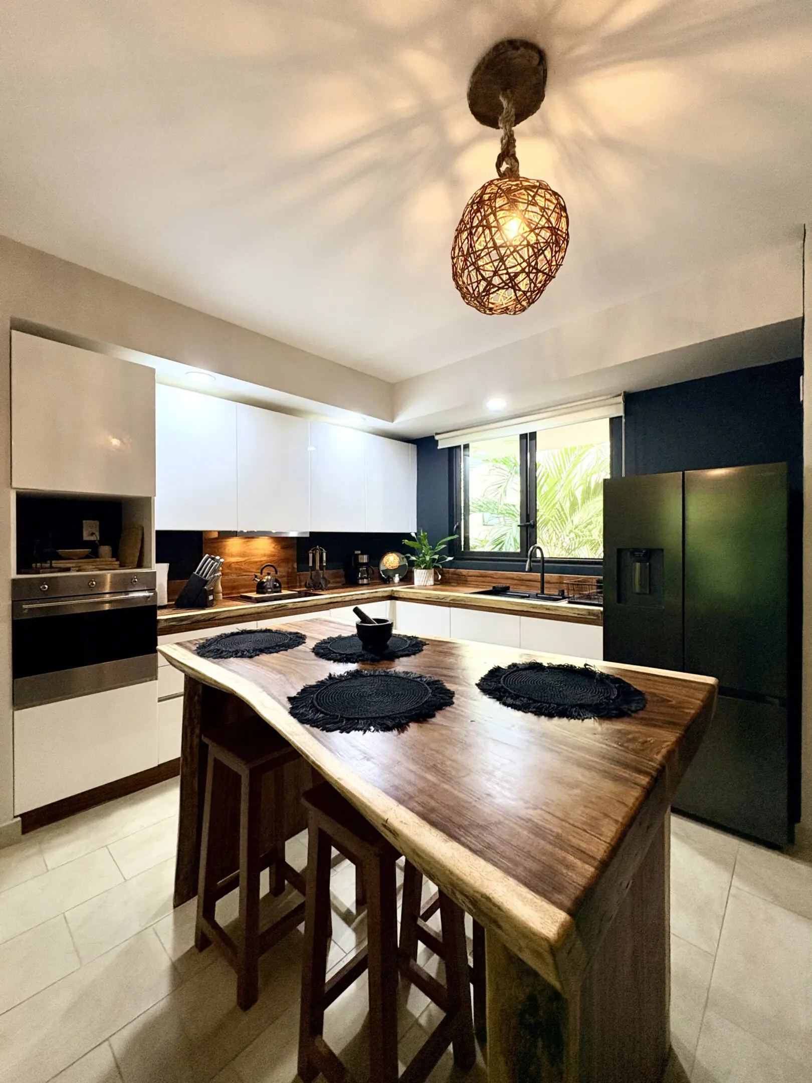 Modern kitchen with wooden island and pendant light