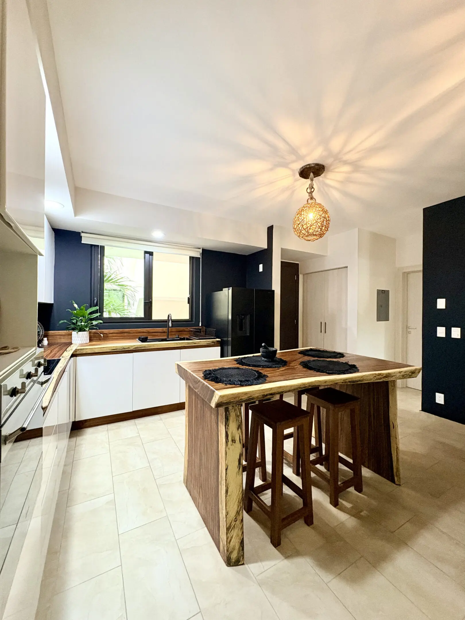 Modern kitchen with wooden island and pendant light