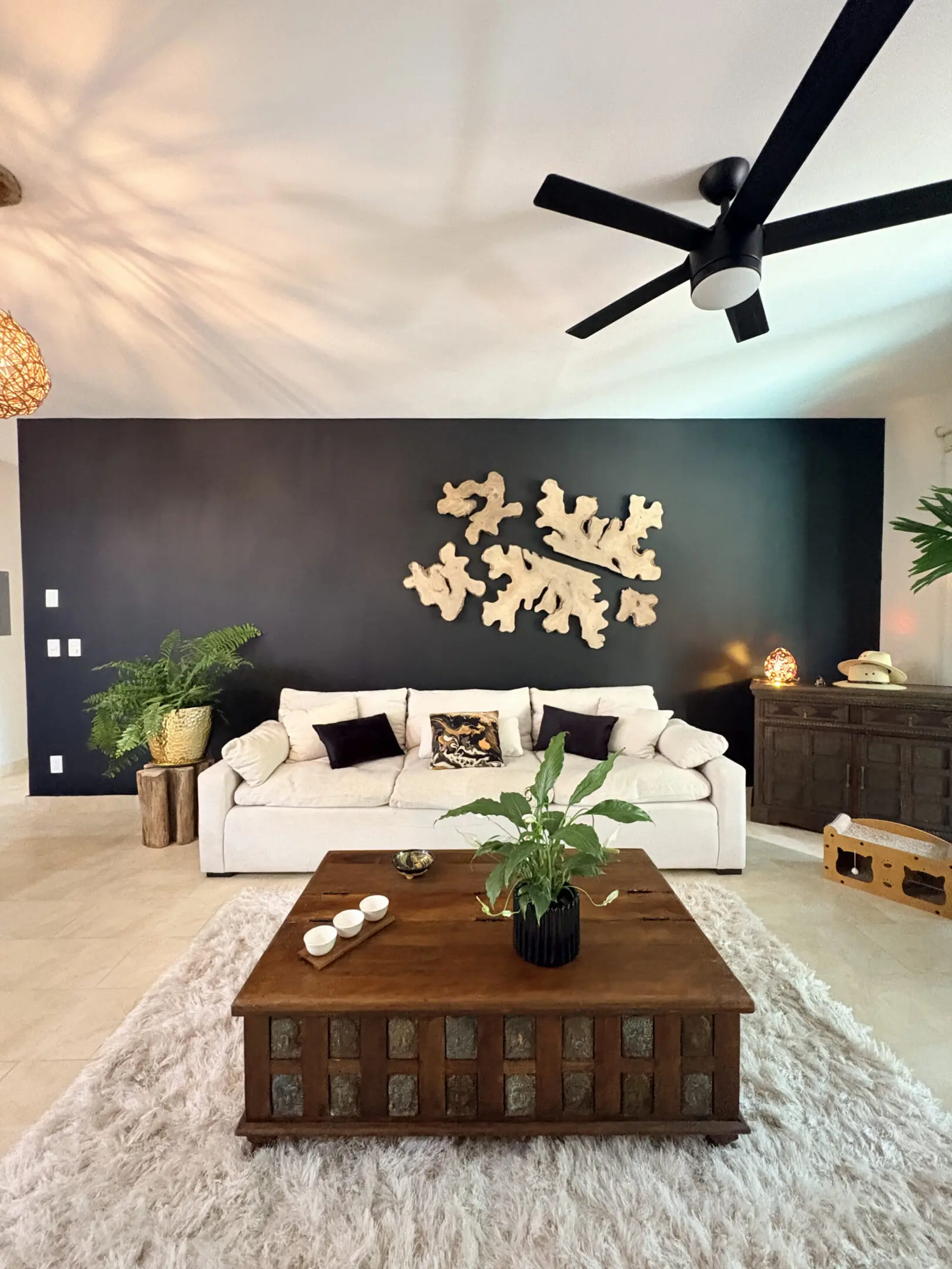 Modern living room with white sofa, dark wall