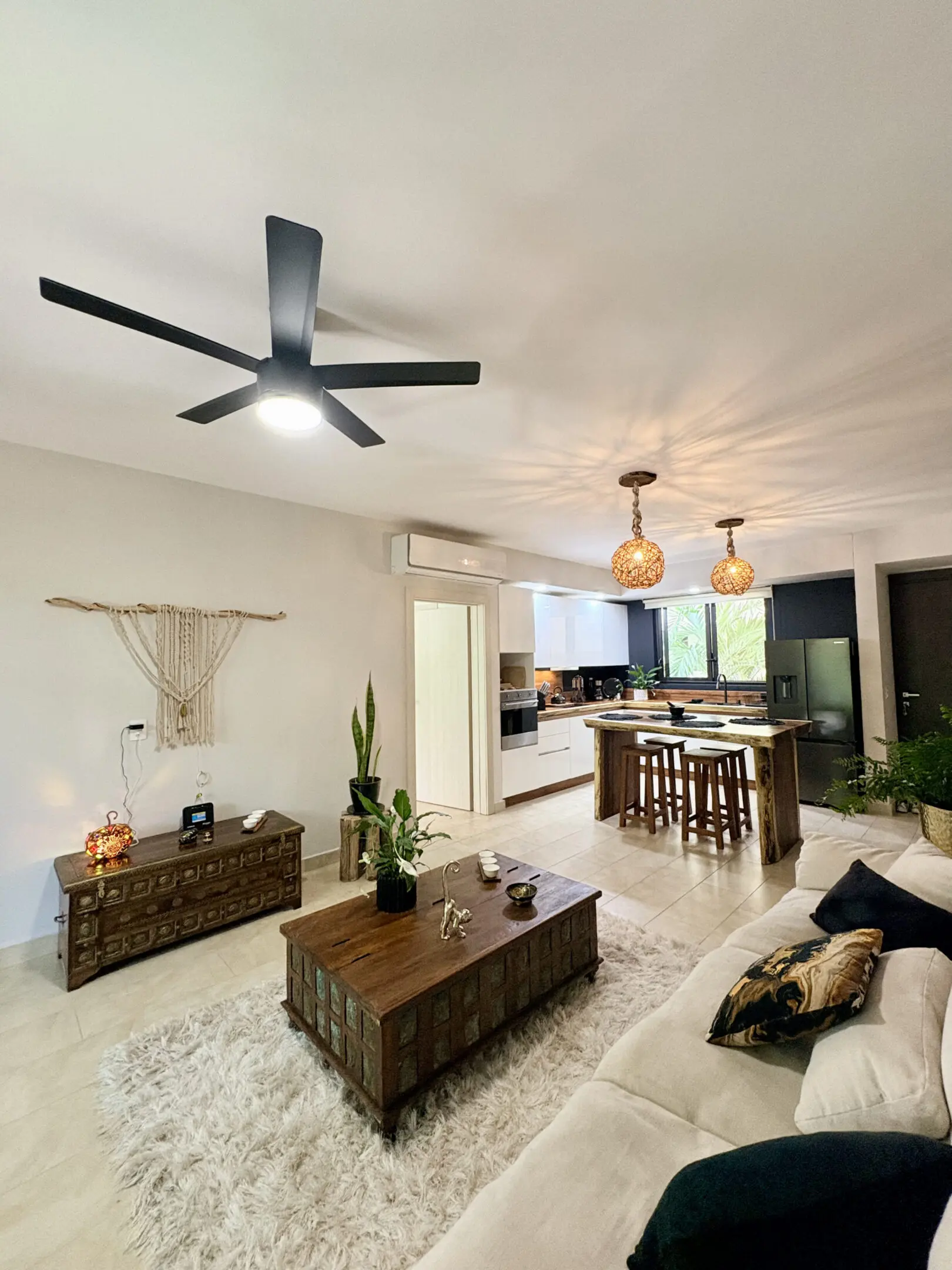 Open-plan living room and kitchen with ceiling fan