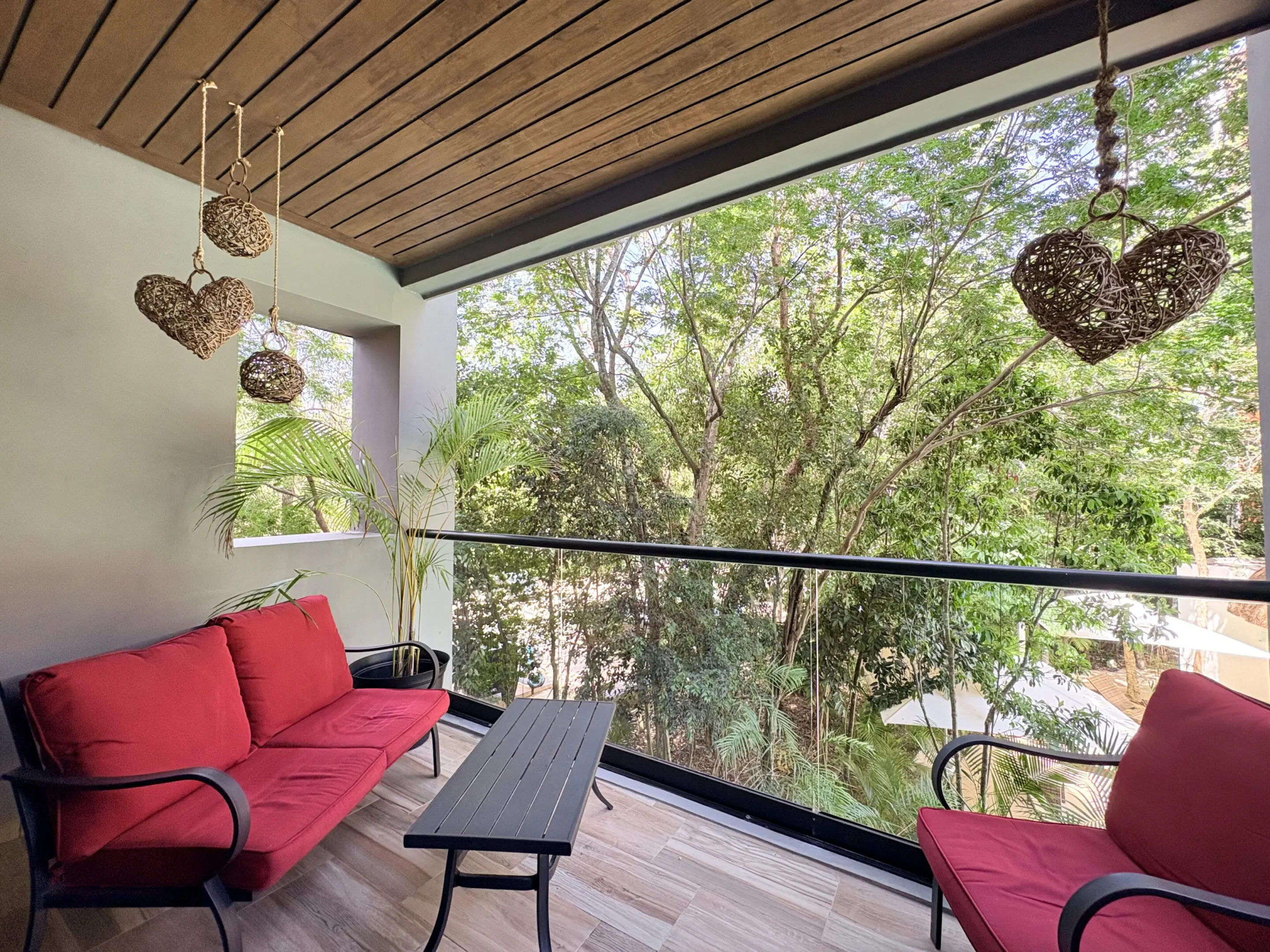 Balcony with red seating and hanging hearts