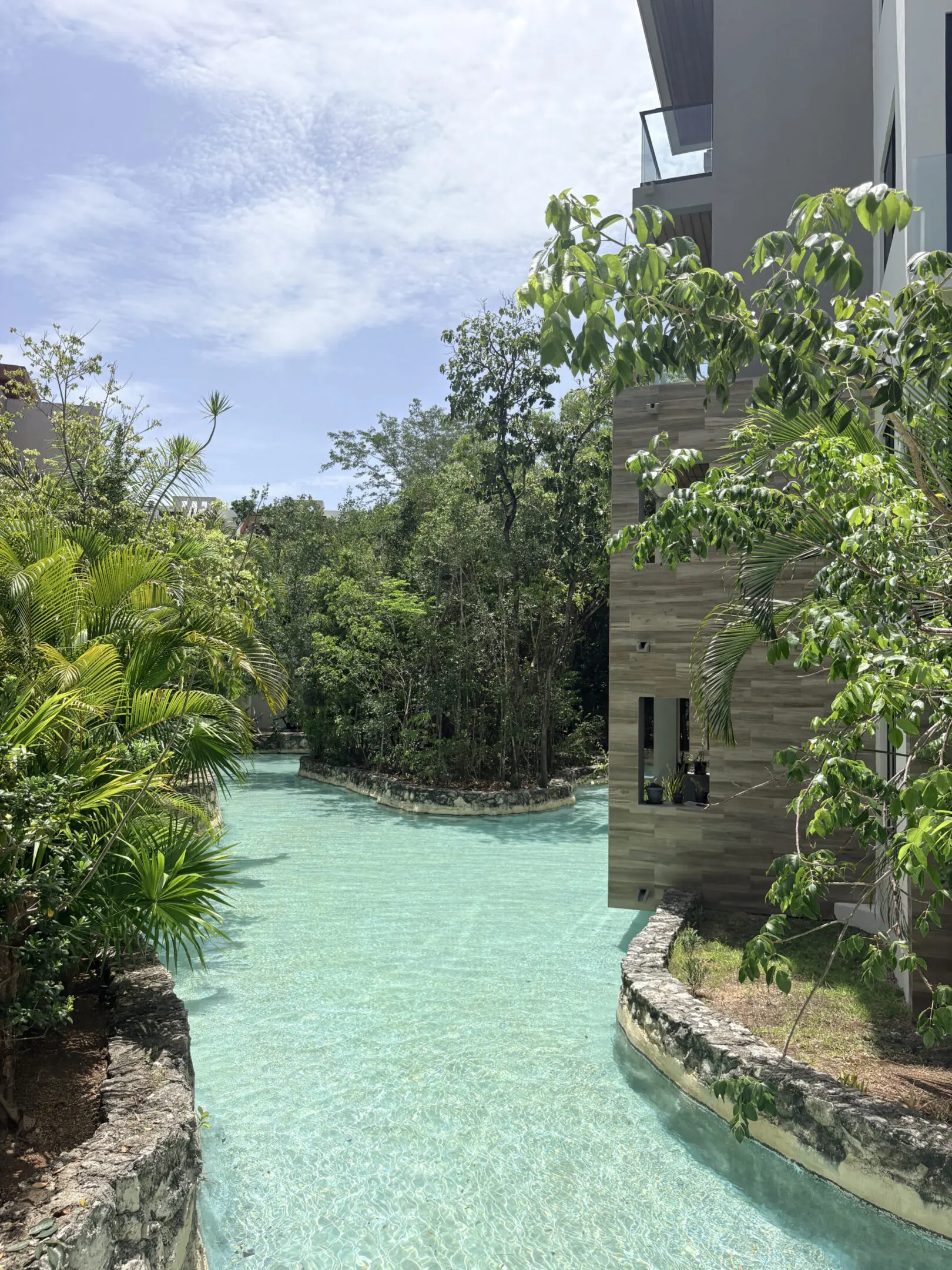 Turquoise pool at tropical resort with building