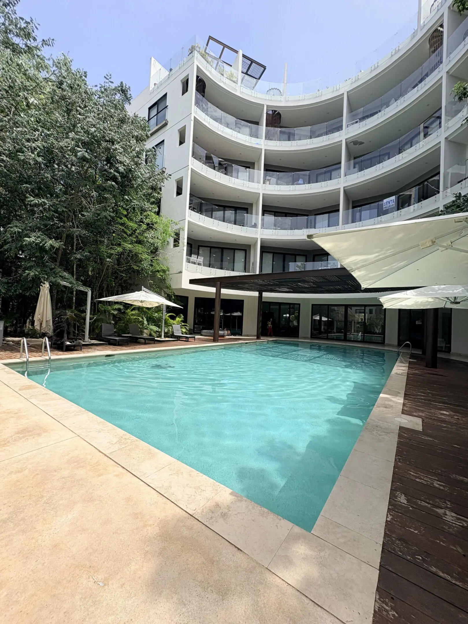 Curved apartment building with outdoor swimming pool