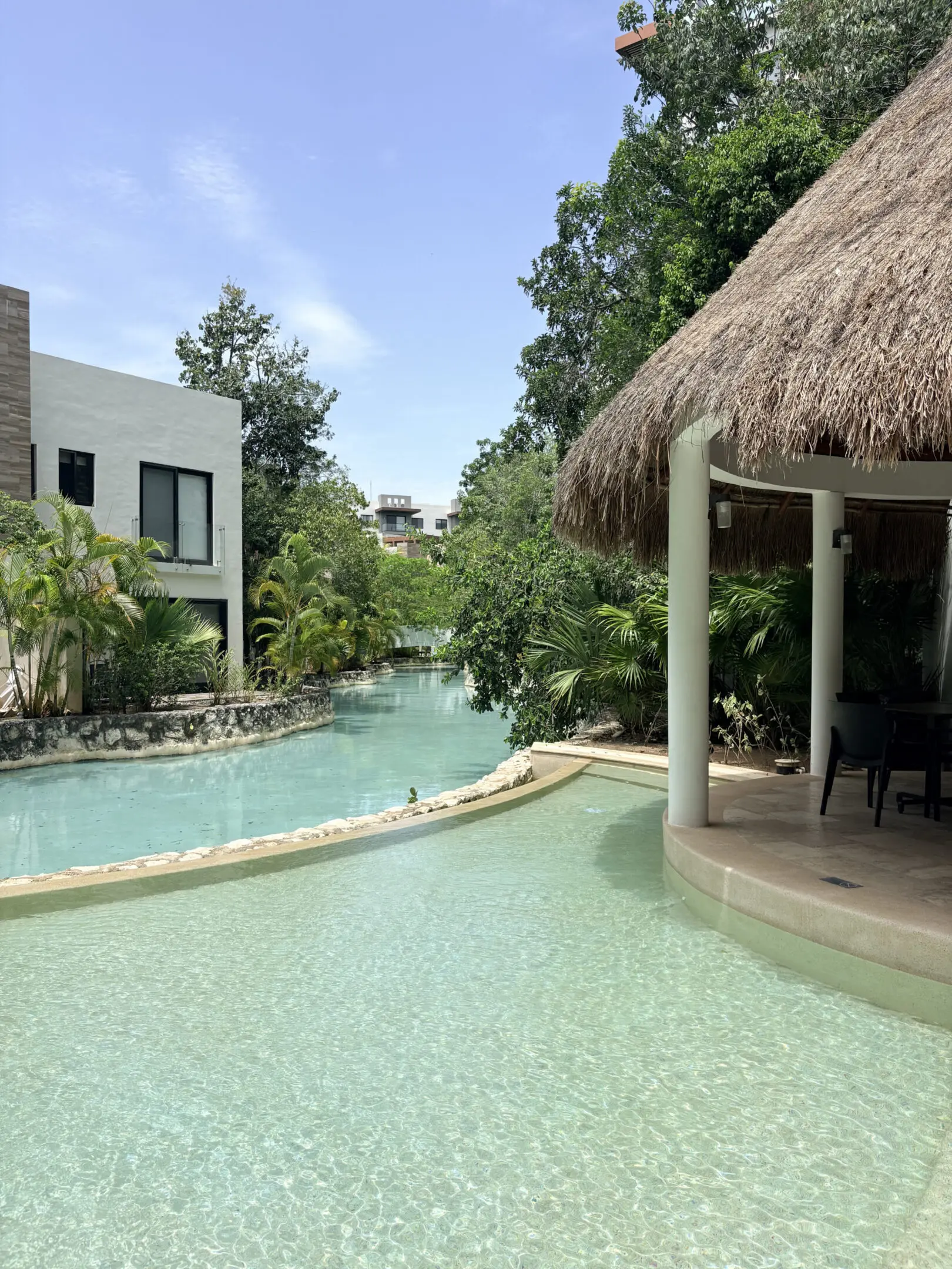 Tropical resort pool with thatched cabana