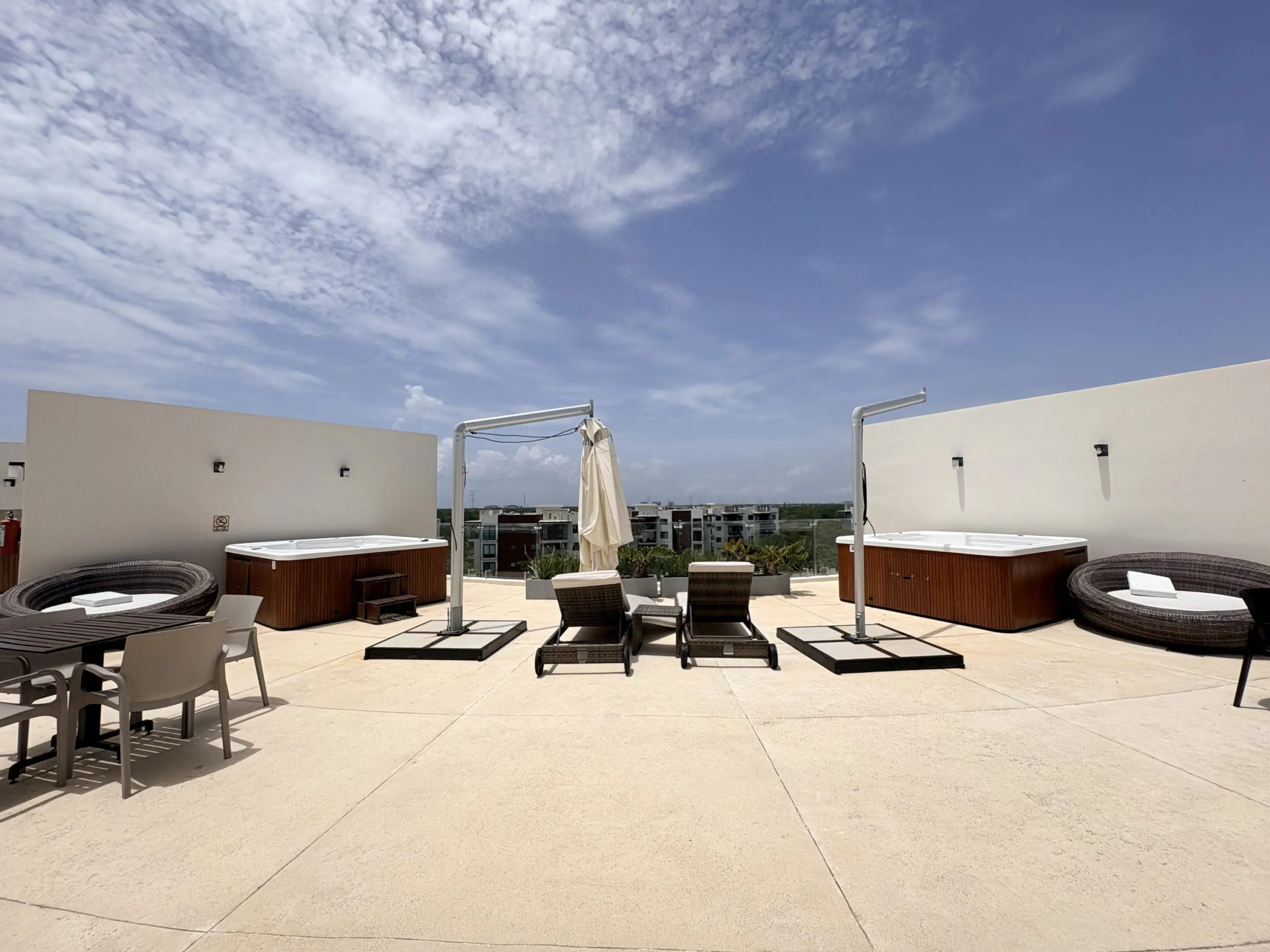 Rooftop terrace with lounge chairs and hot tubs