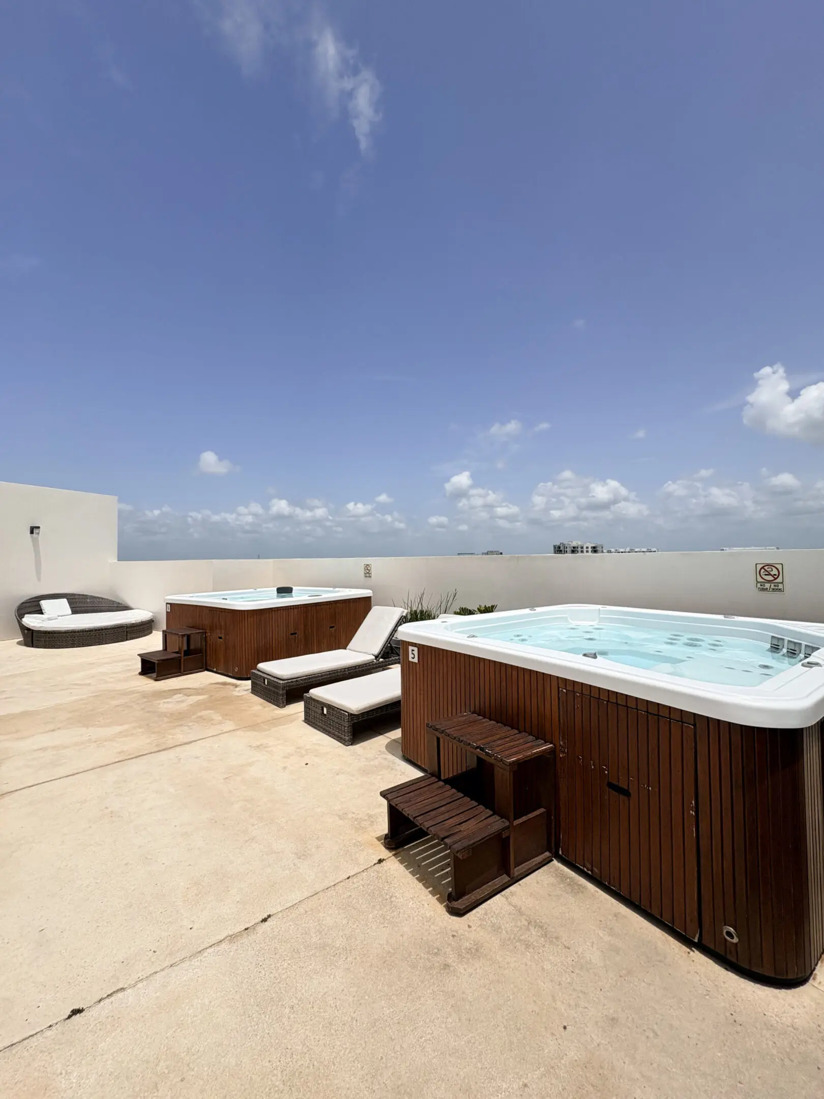 Rooftop hot tubs with lounge chairs