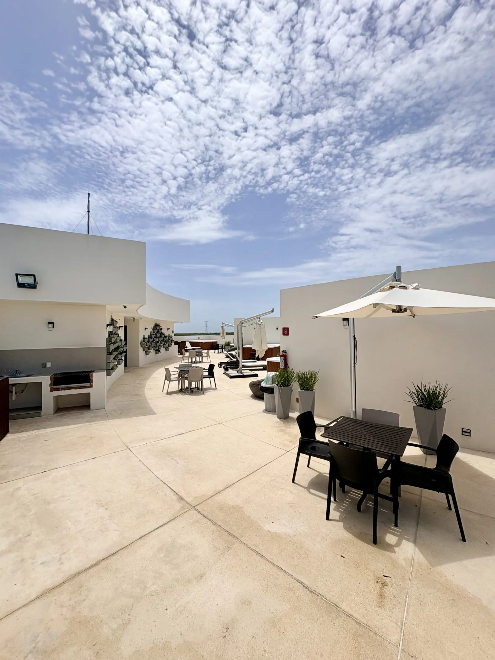 Modern rooftop terrace with tables and umbrellas