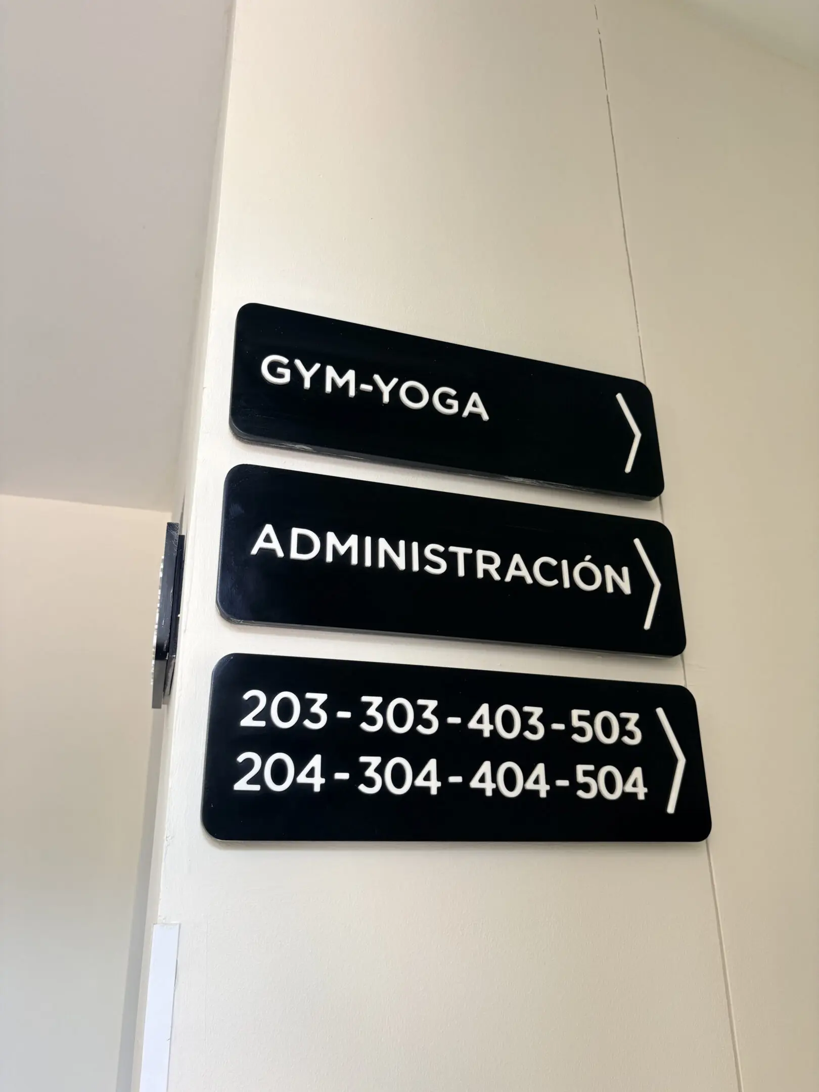 Directional wall signs: gym, administration, room numbers