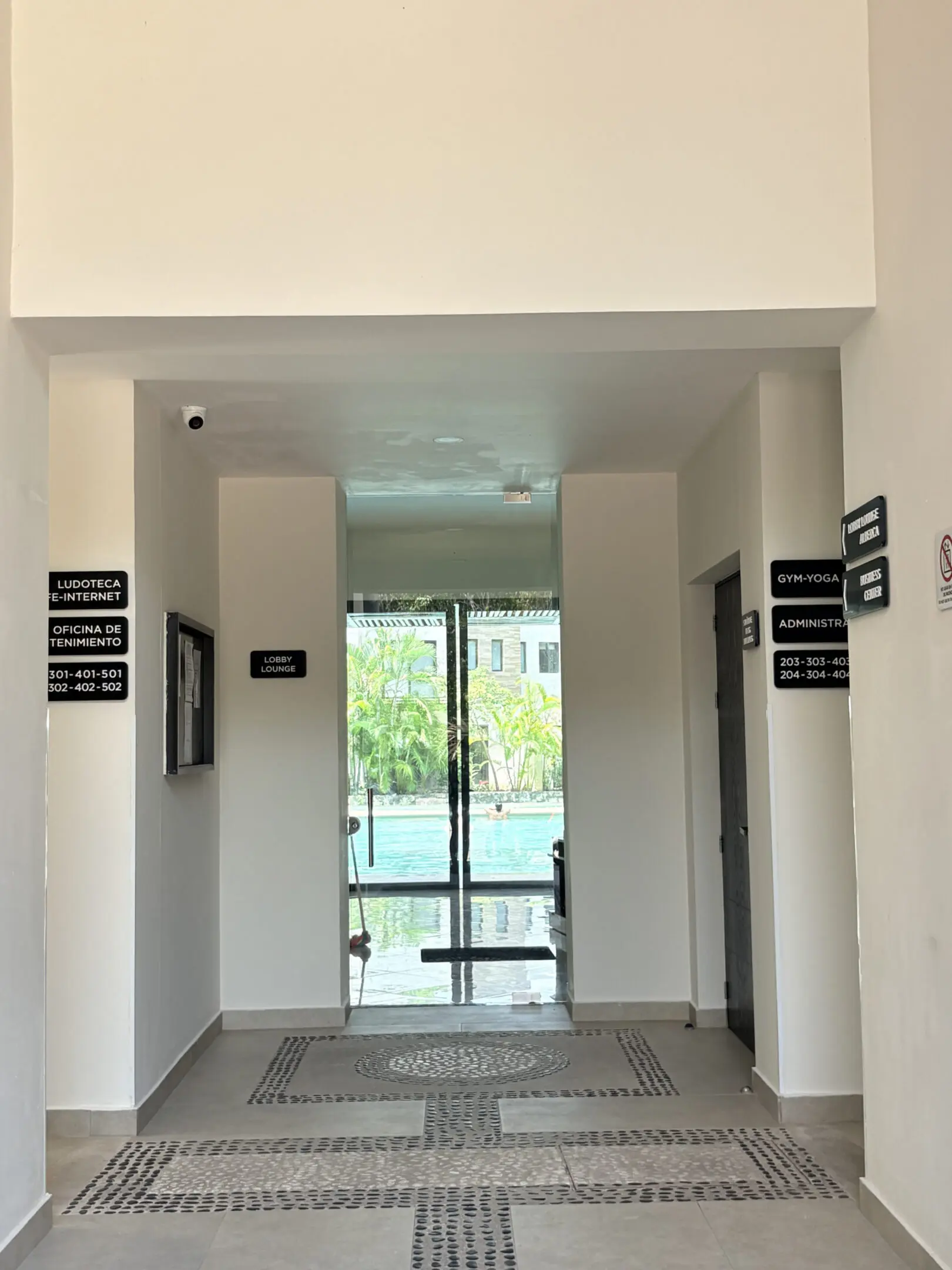 Hallway leading to glass doors overlooking pool