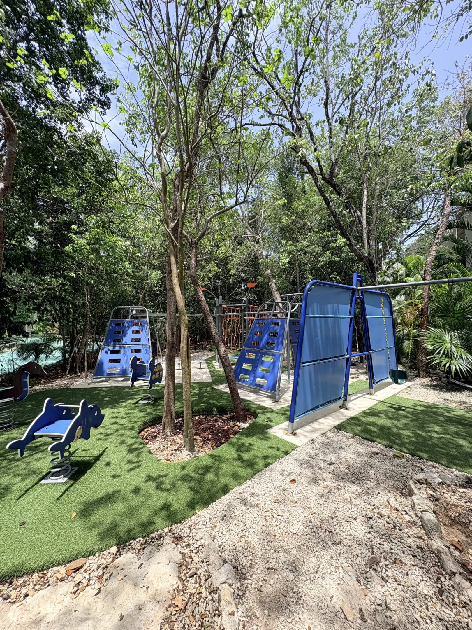 Blue playground with swings and climbing structures