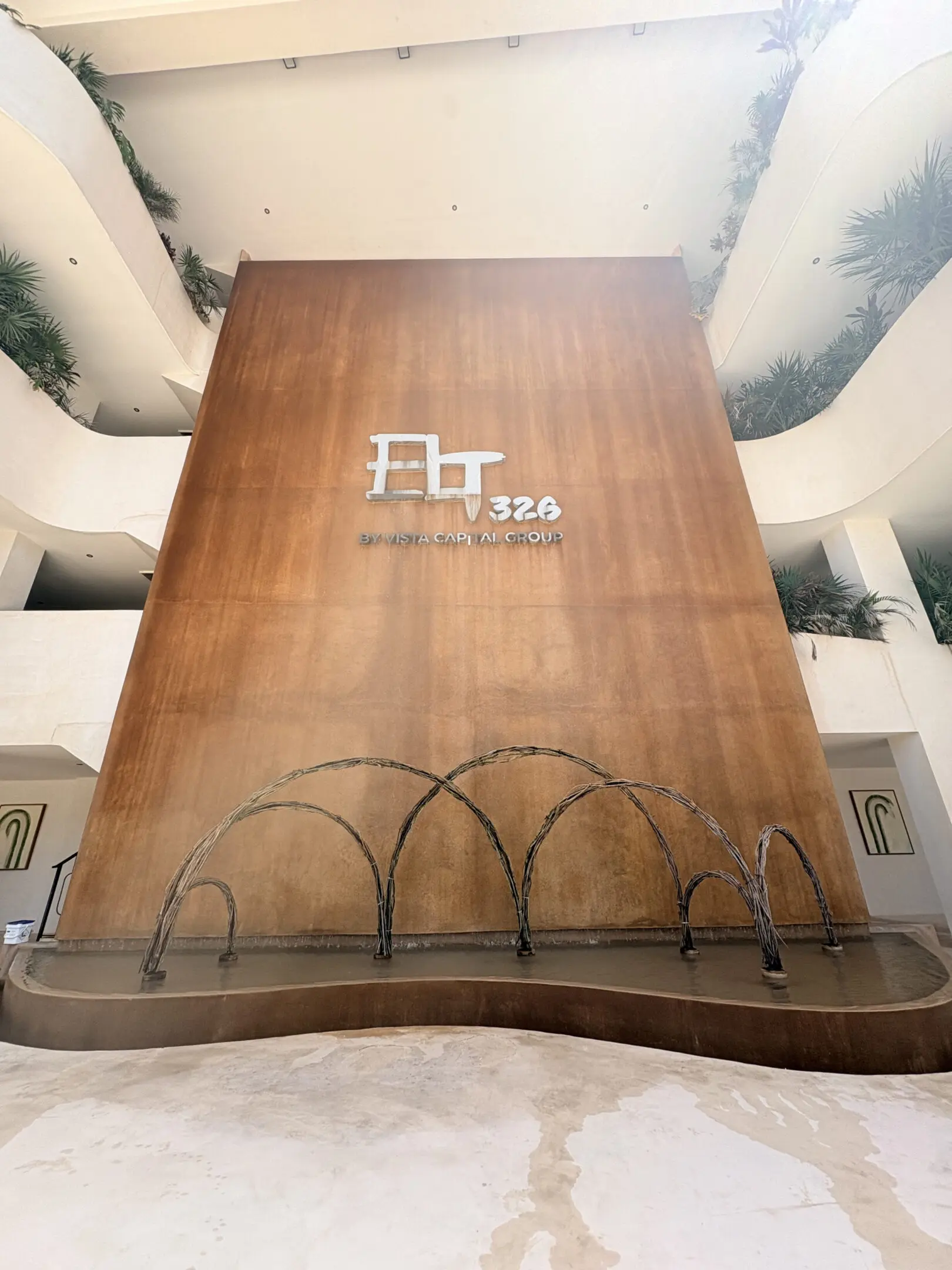 Tall atrium with wooden wall and fountain