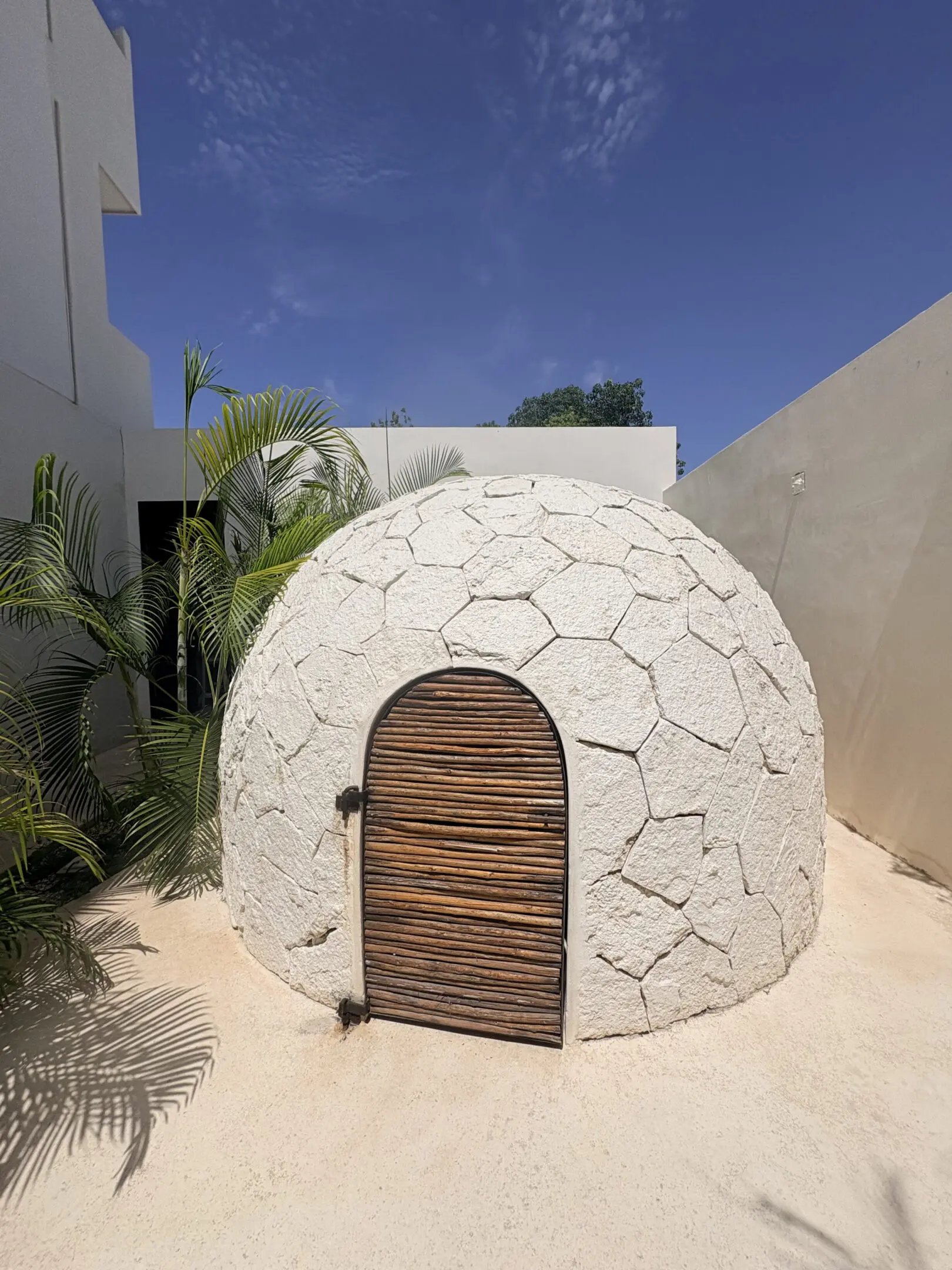 White stone dome with wooden arched door