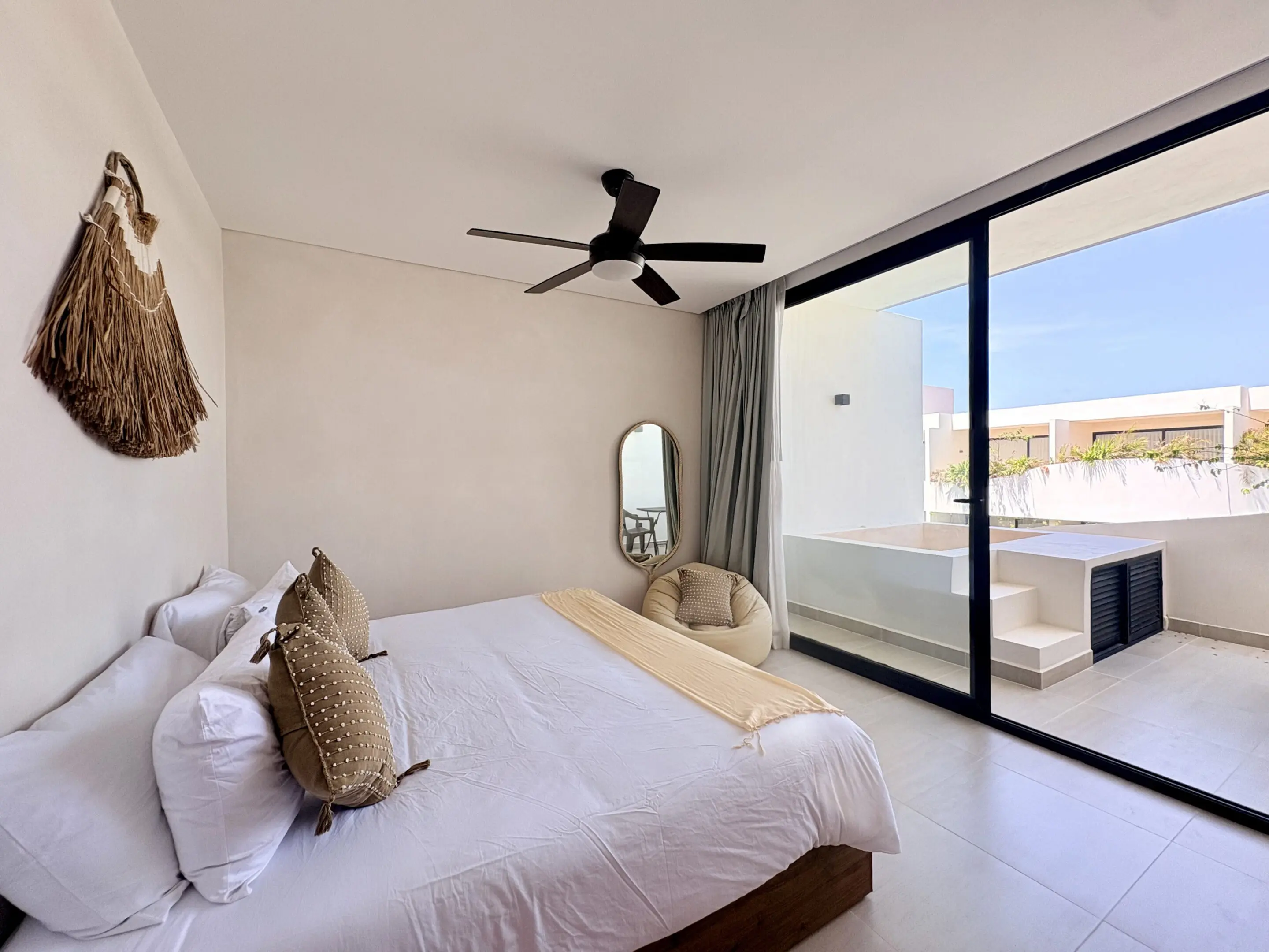 Minimalist bedroom with balcony and ceiling fan