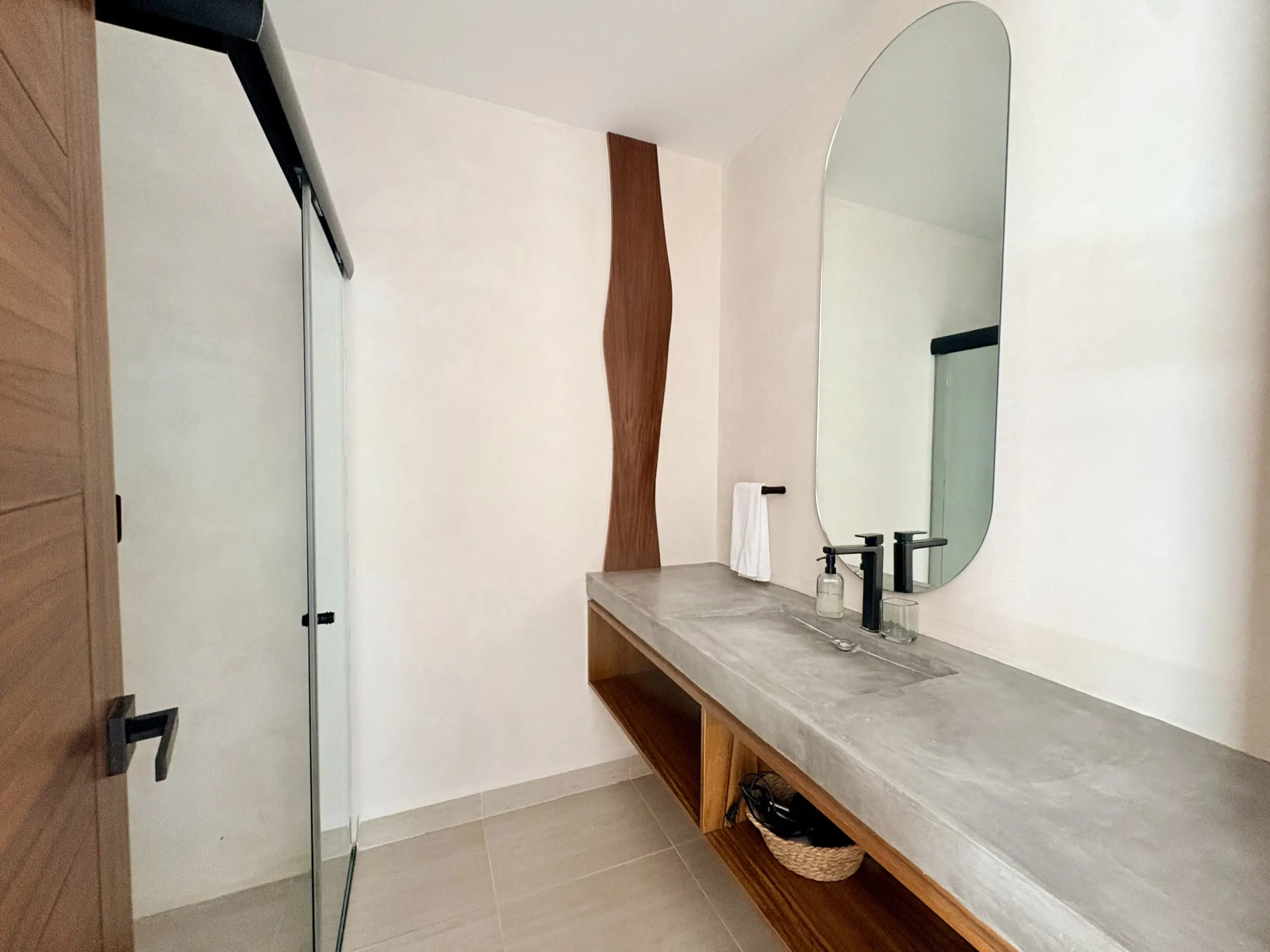 Minimalist bathroom with concrete vanity and mirror