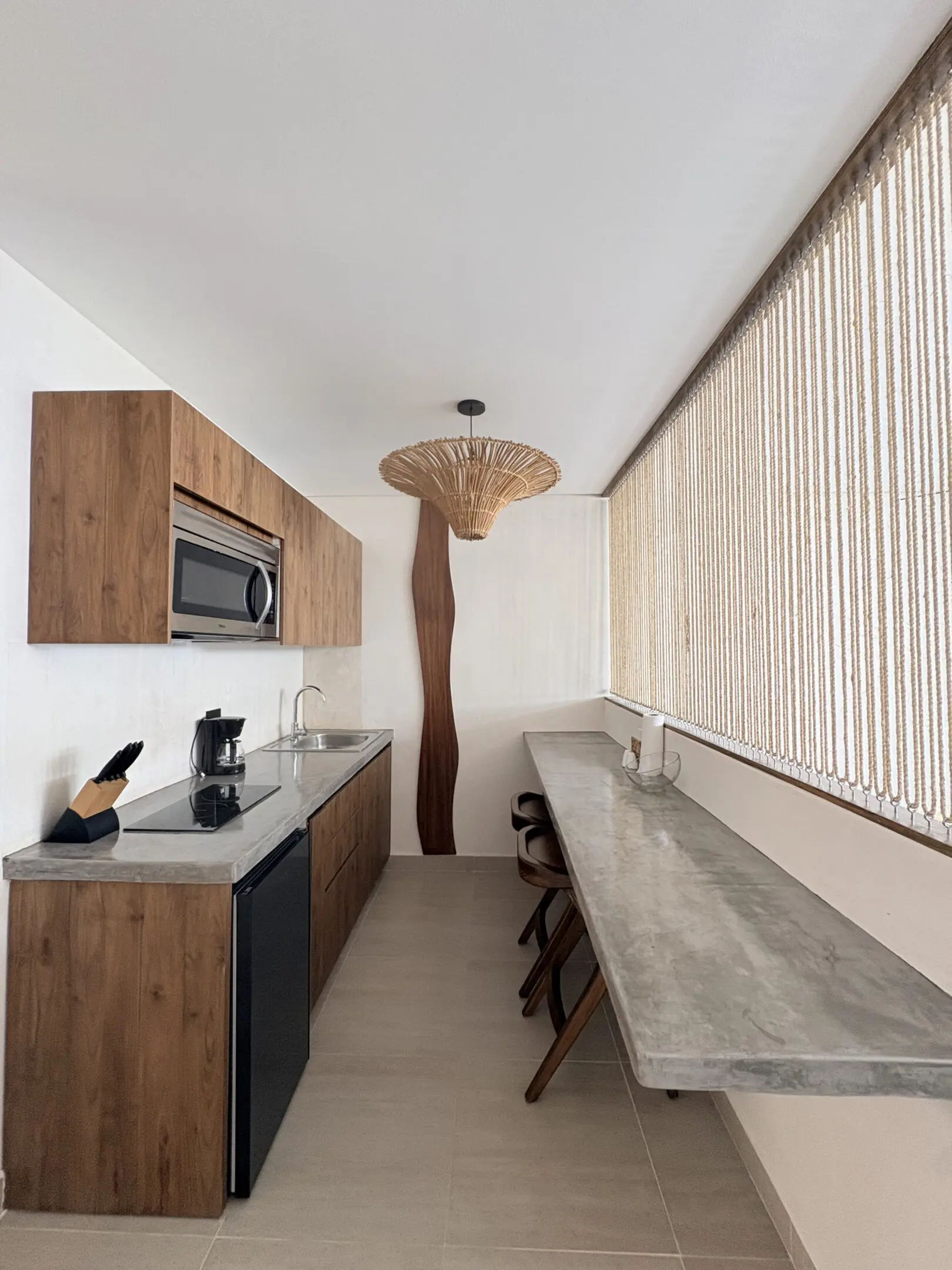 Modern narrow kitchen with wooden cabinets, concrete countertop