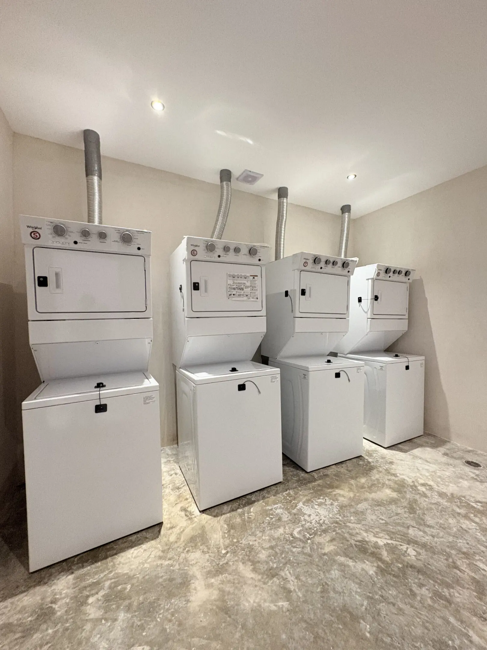 Four stacked washer-dryers in laundry room