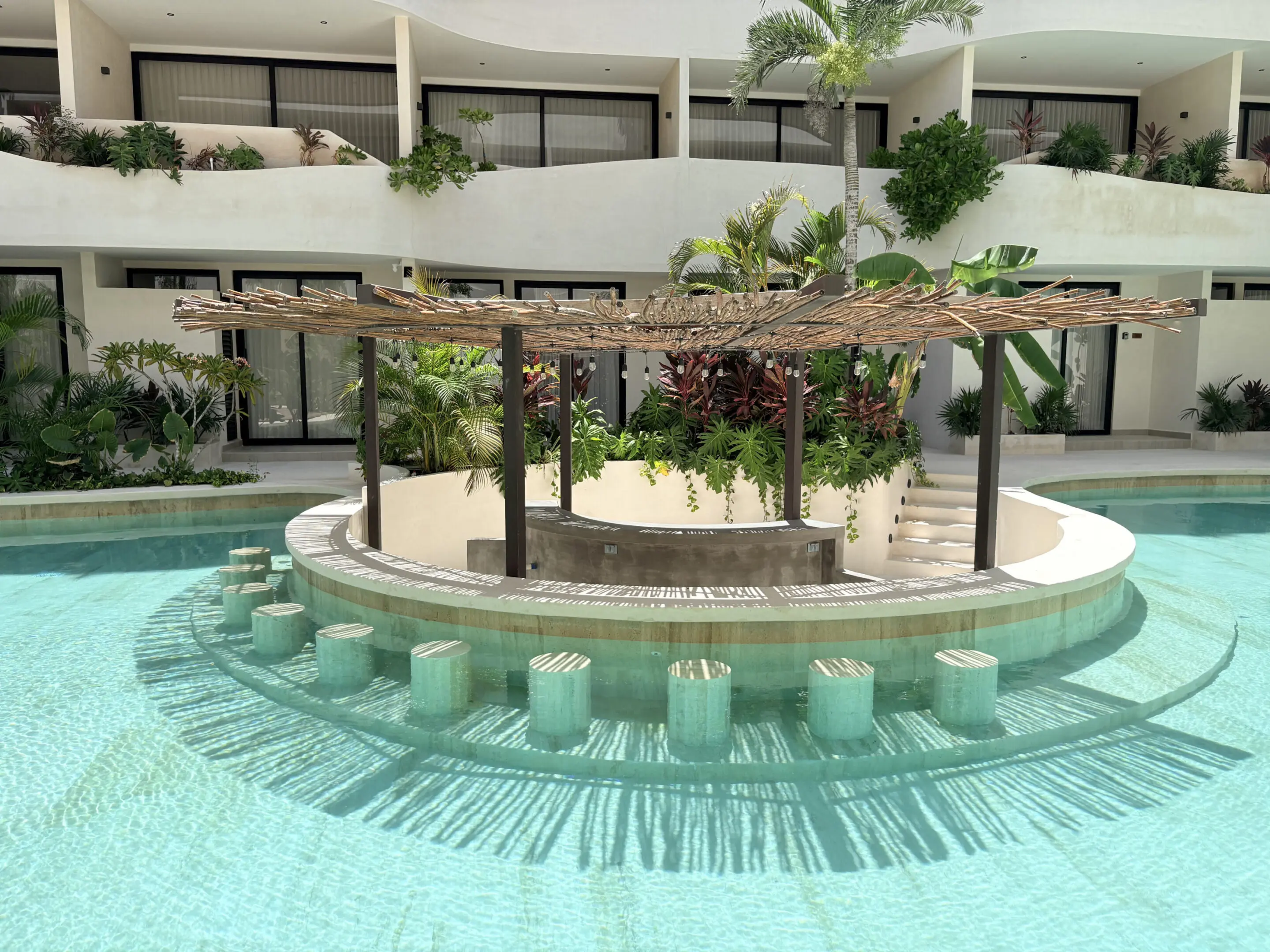 Tropical resort pool bar with thatched pergola