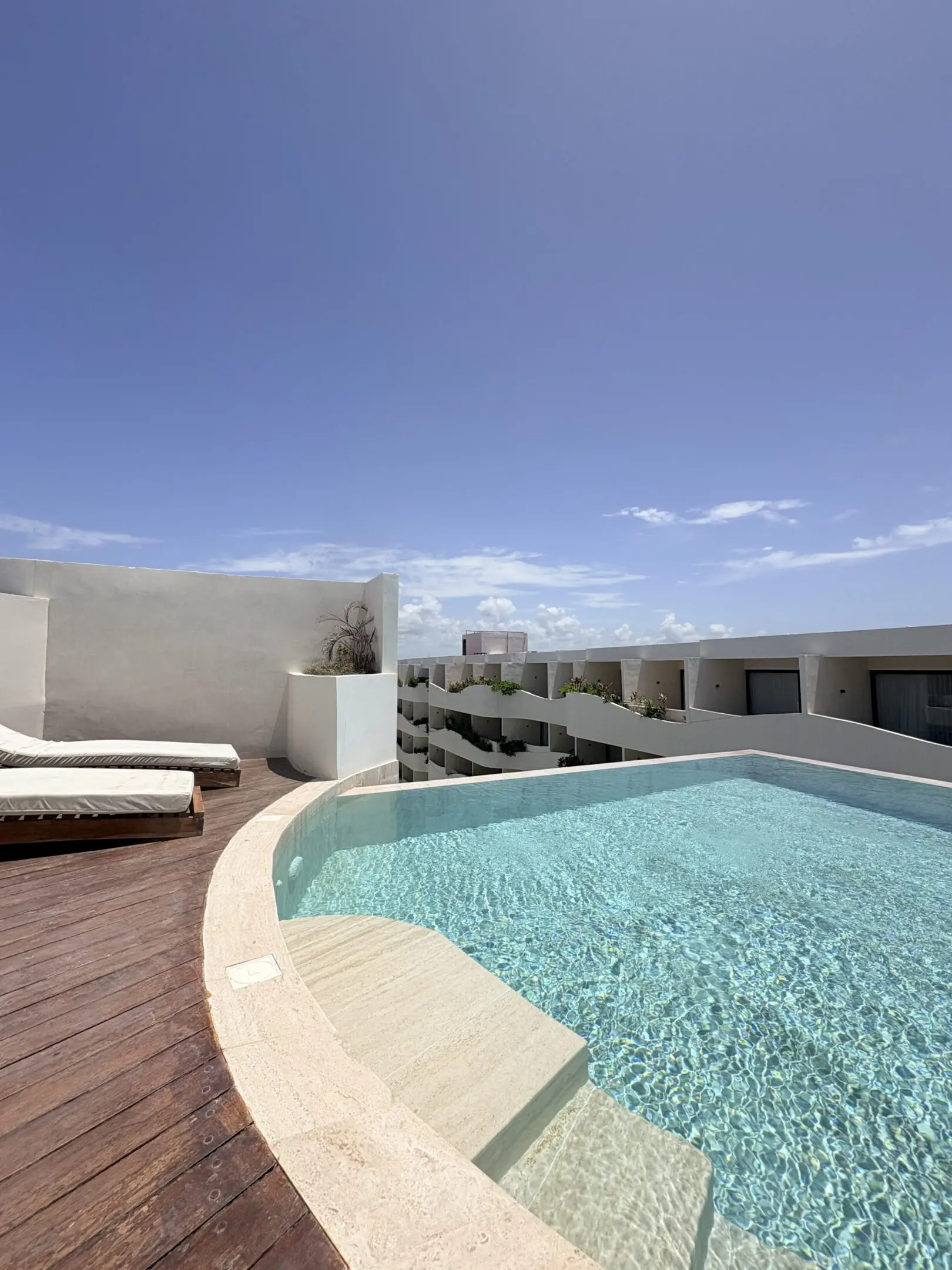 Rooftop pool with lounge chairs and deck