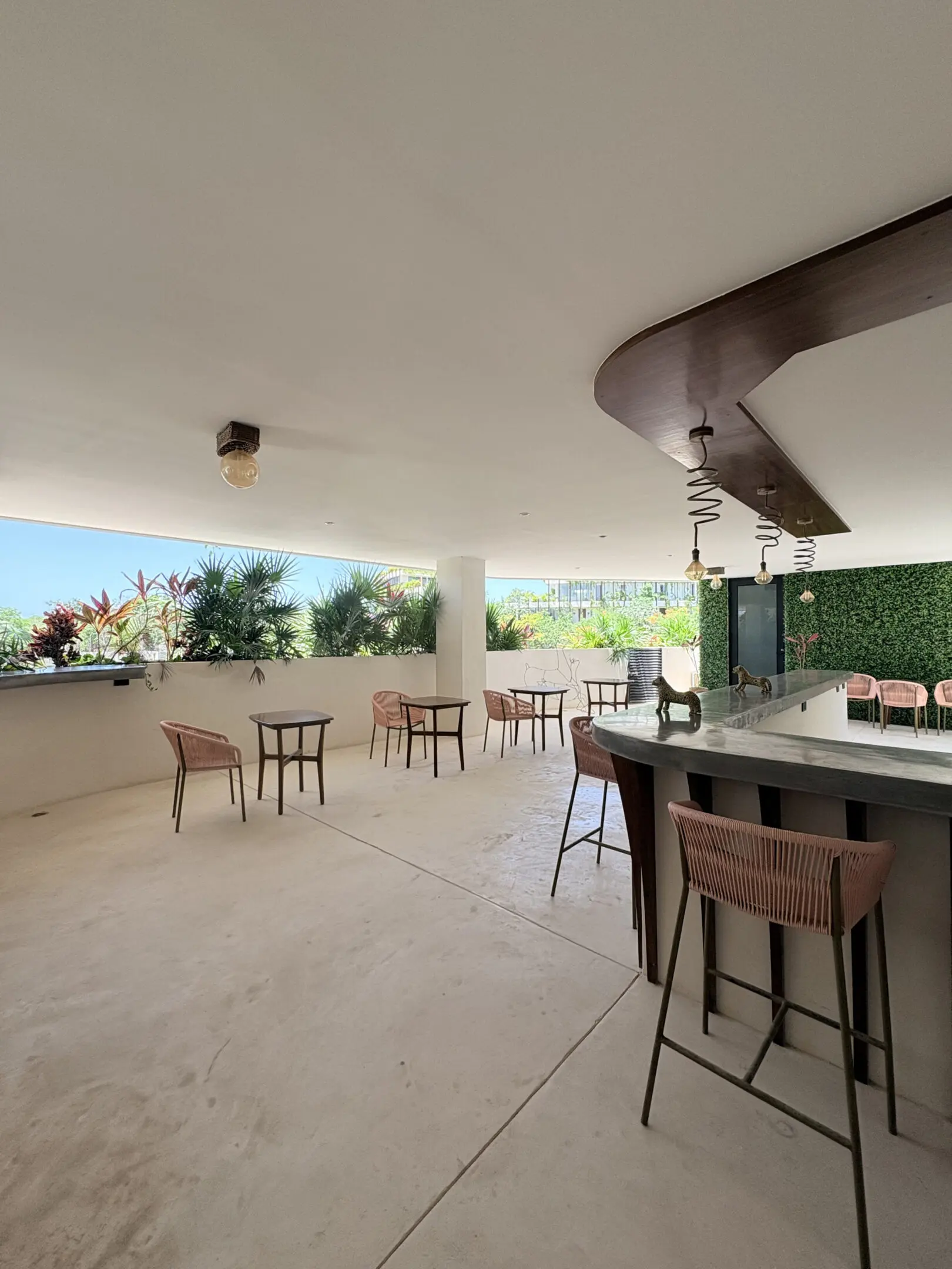 Covered outdoor bar with seating and plants