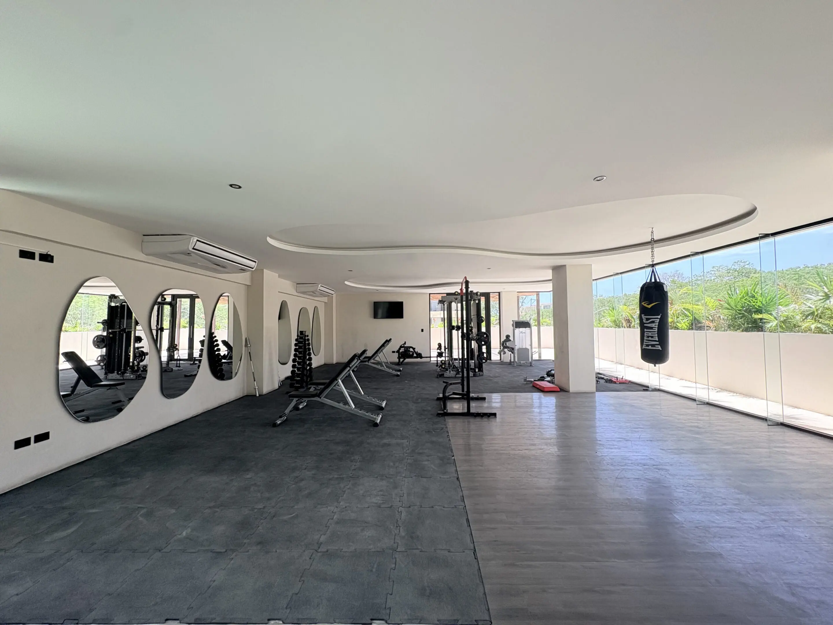 Modern gym interior with equipment and punching bag