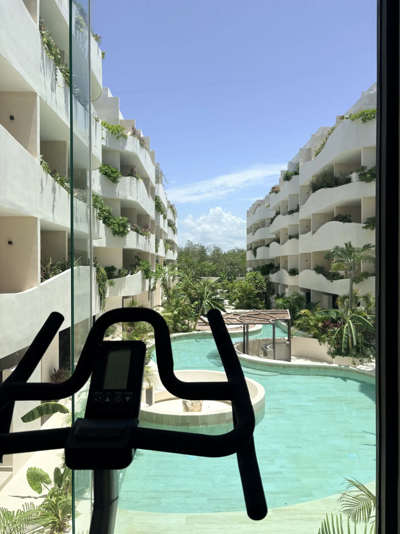 Indoor exercise bike overlooking resort pool