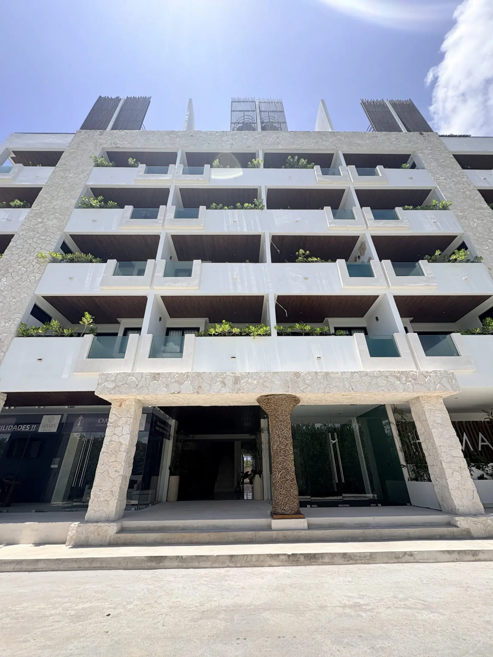 Modern building facade with balconies and plants