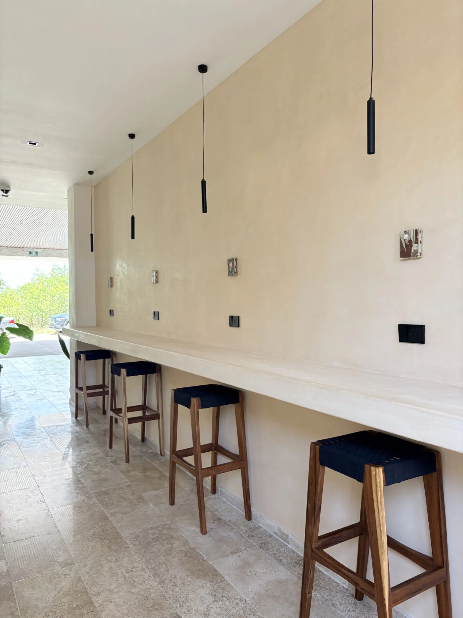 Minimalist bar counter with wooden stools