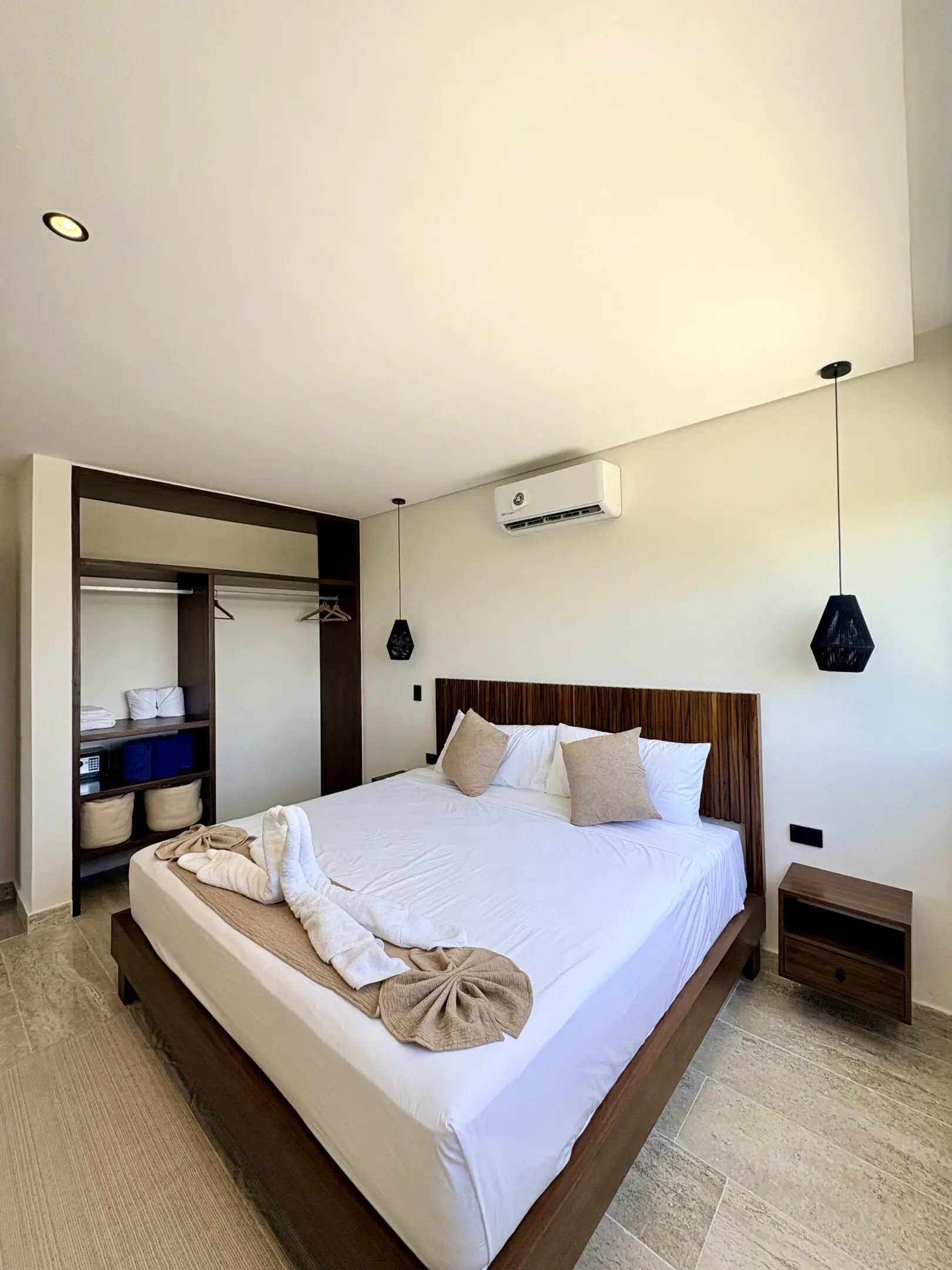 Modern bedroom with bed, pendant lights, open closet