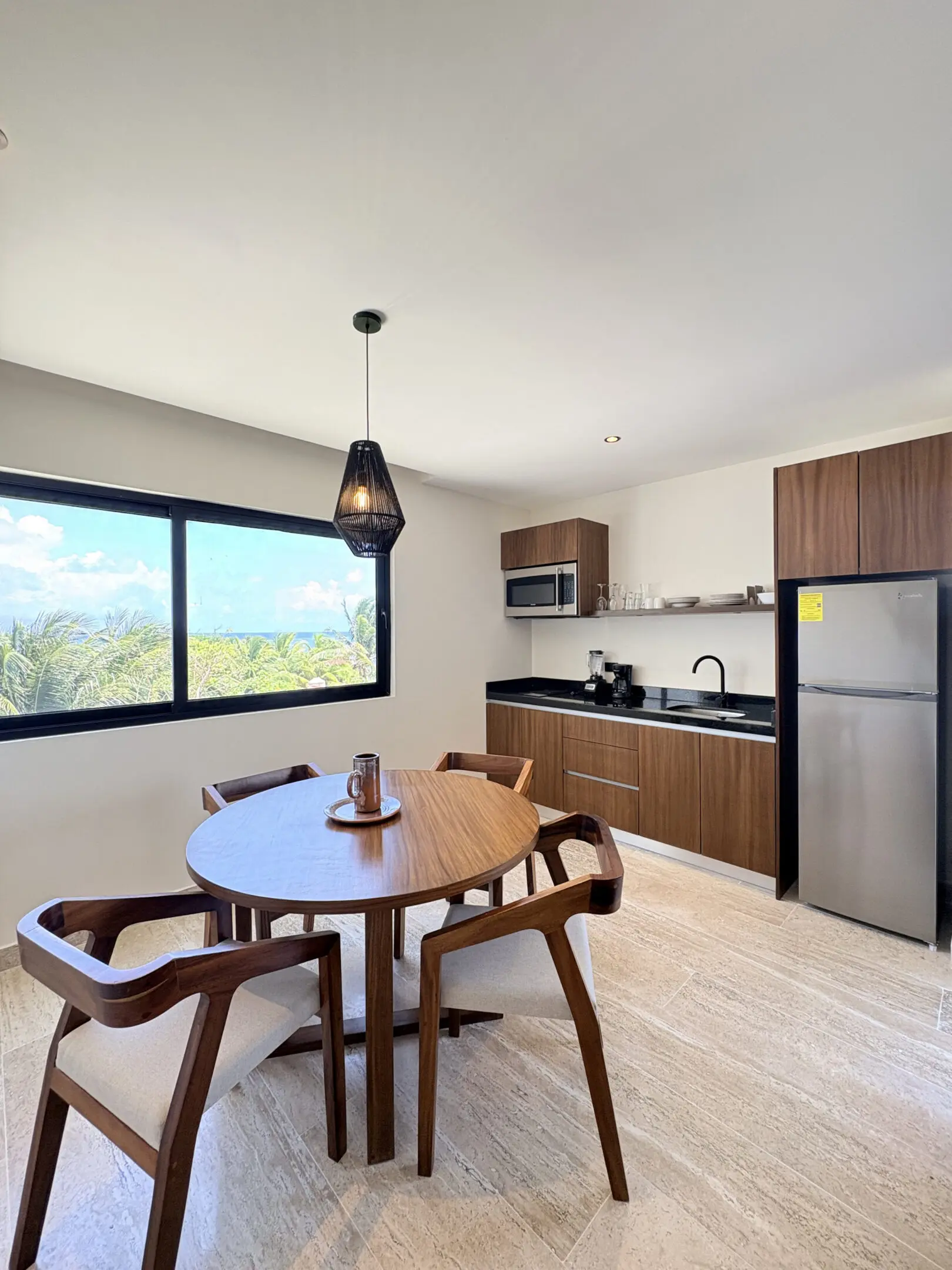 Modern kitchenette with round wooden dining table