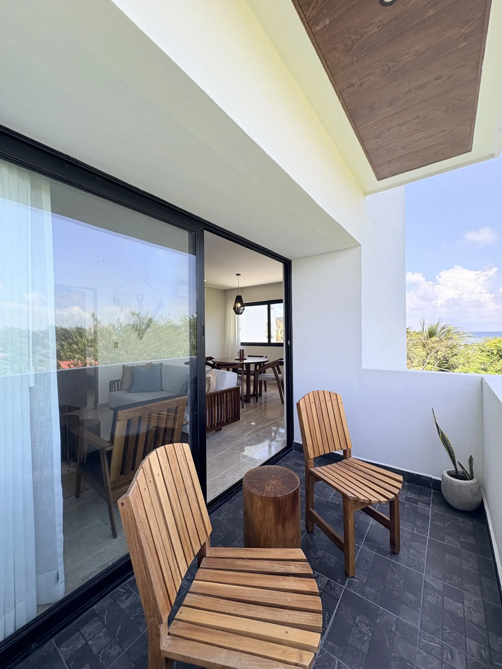 Balcony with wooden chairs and stump table