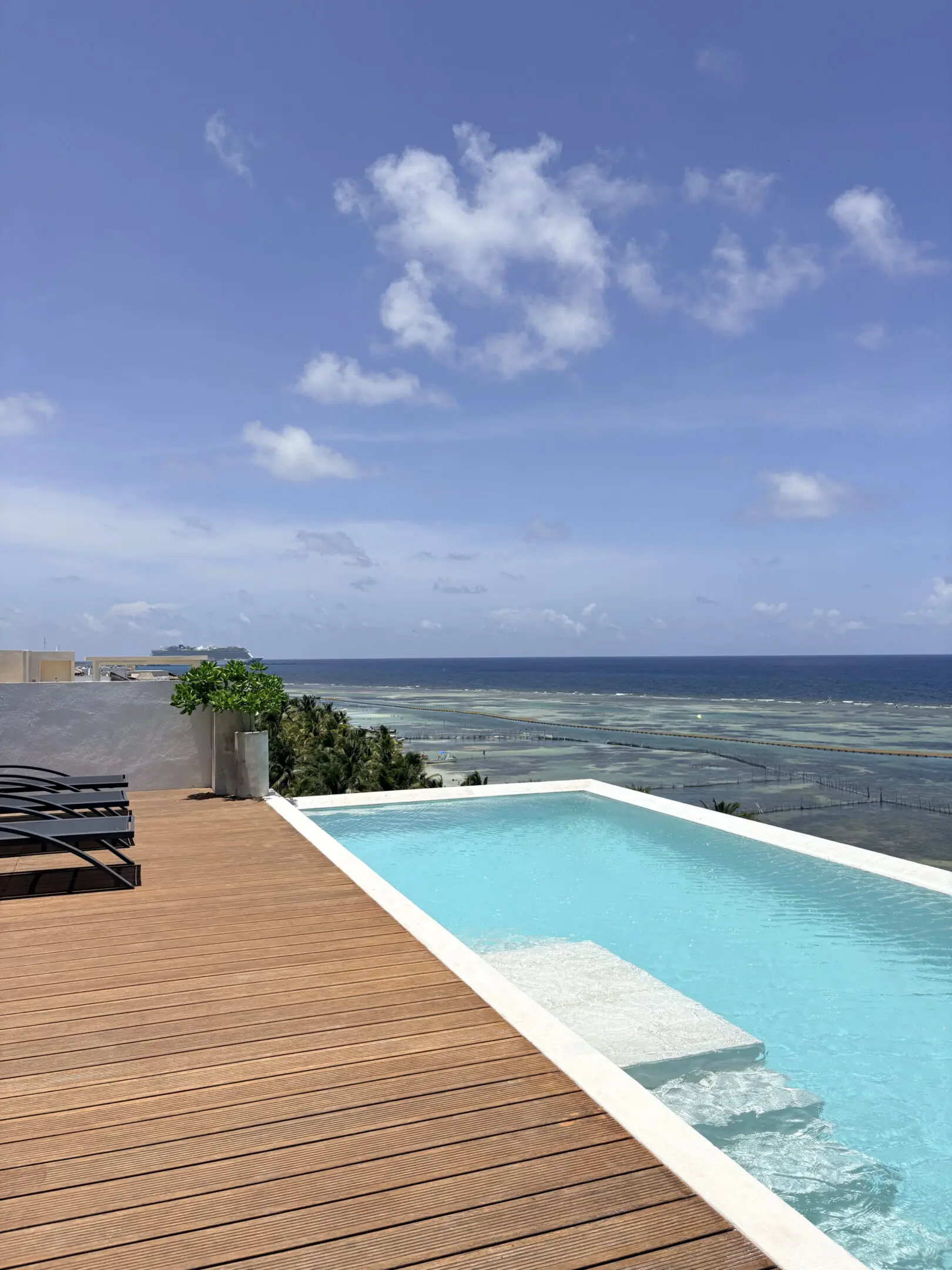 Rooftop infinity pool overlooking clear blue ocean