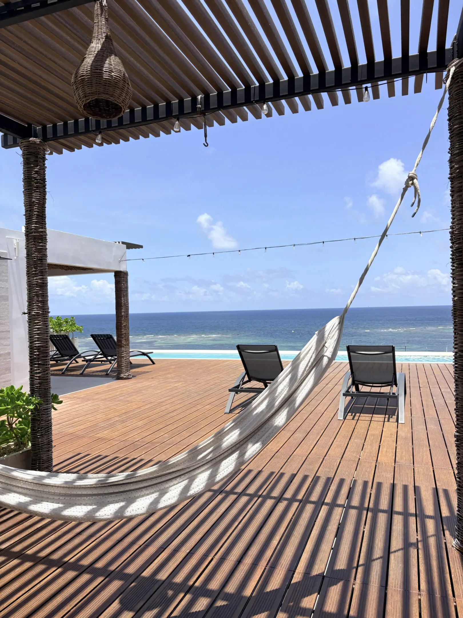Hammock and lounge chairs on oceanfront deck