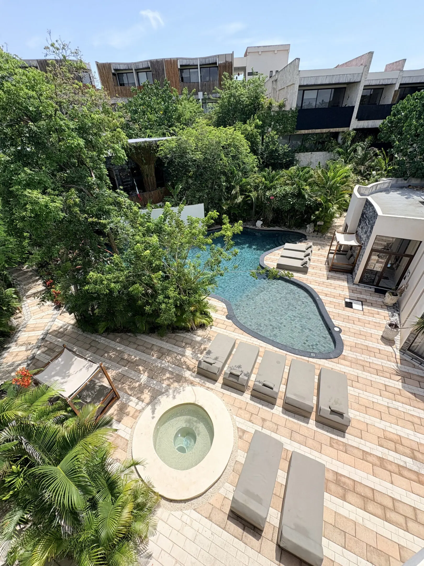 Aerial view of tropical hotel pool courtyard