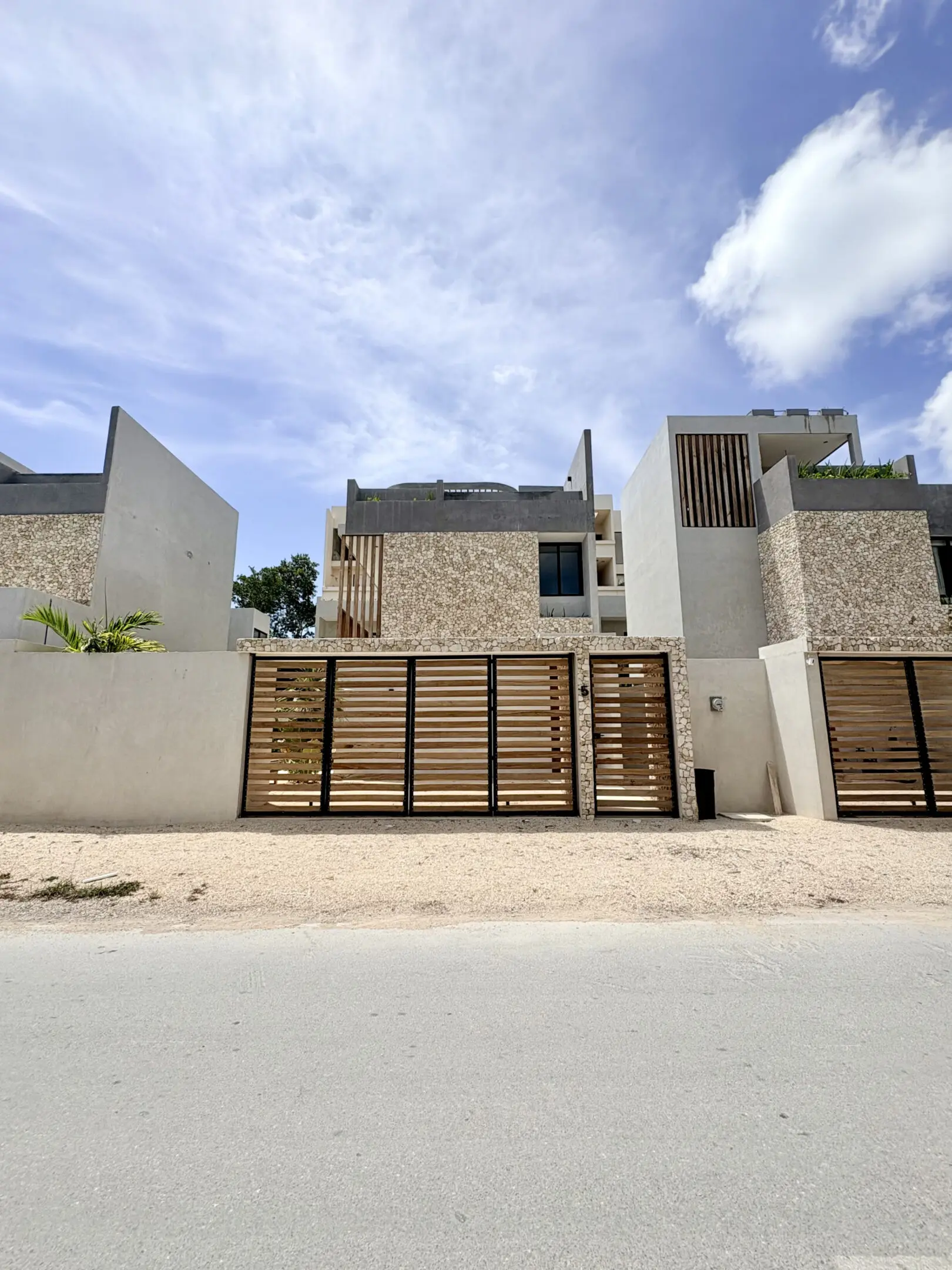 Contemporary beachfront houses with wooden slat gates