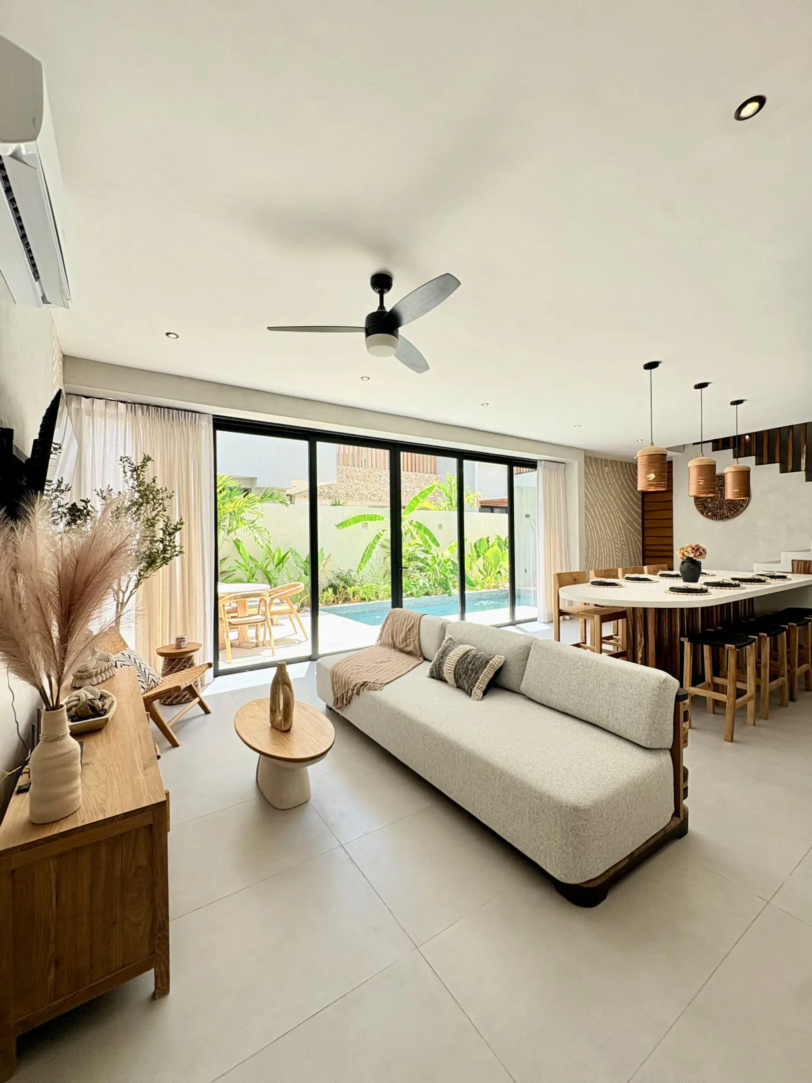 Modern open-plan living room with pool view
