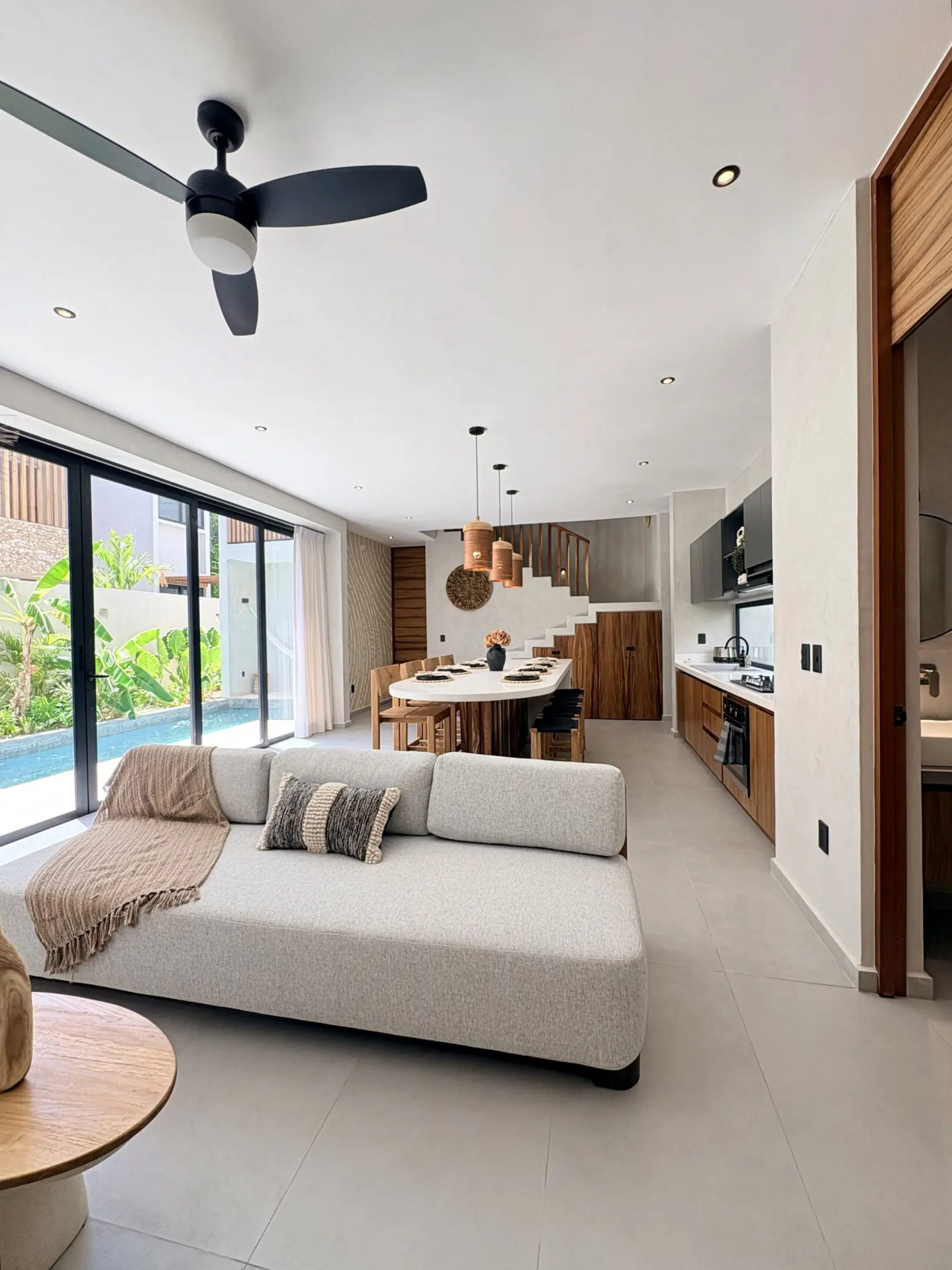 Modern open-plan living room with pool view