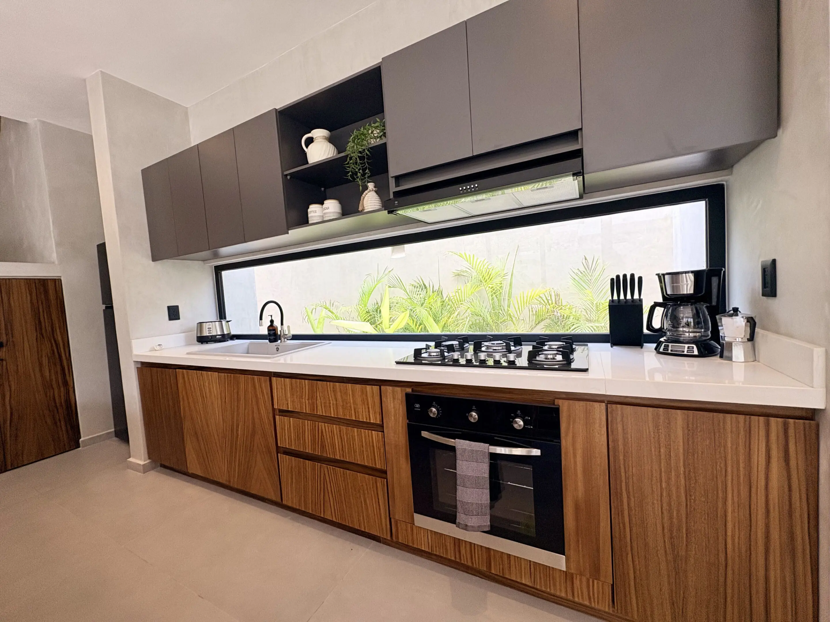 Modern kitchen with wood cabinets and window