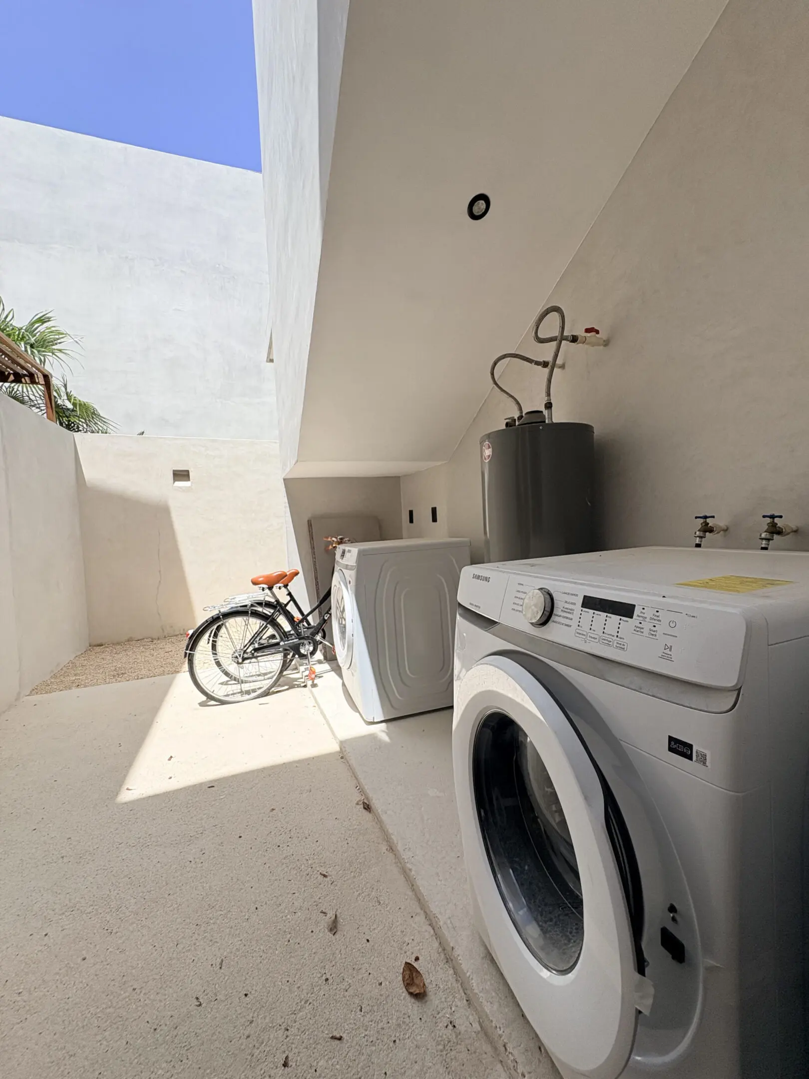 Outdoor laundry area with washer, dryer, bicycle