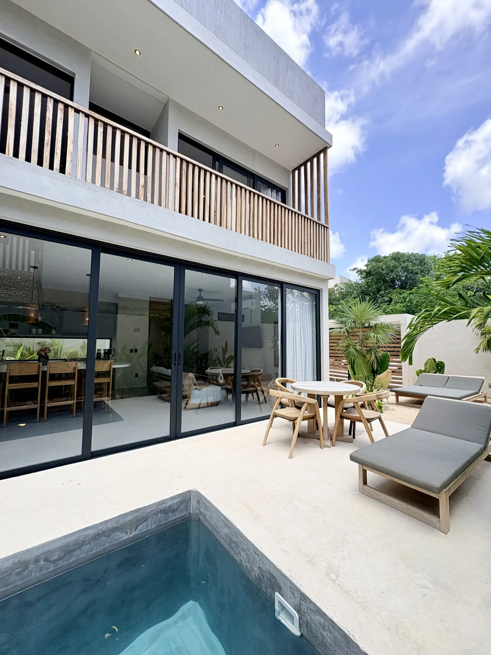 Modern villa patio with pool and lounge chairs
