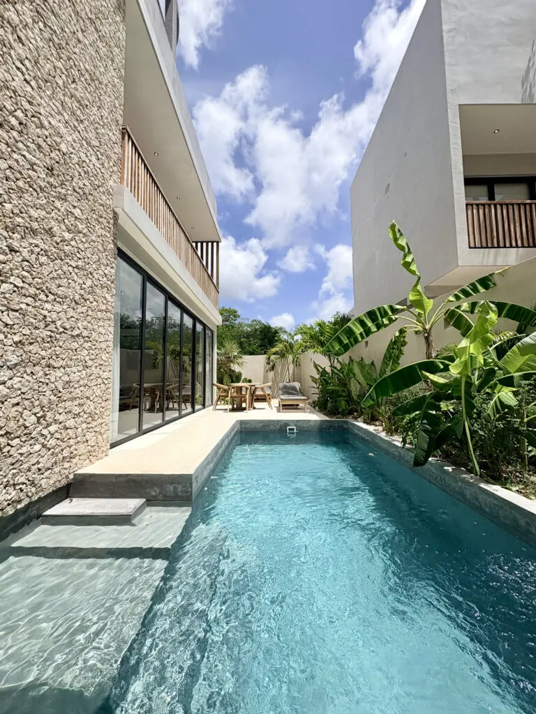 Private courtyard pool between modern white buildings