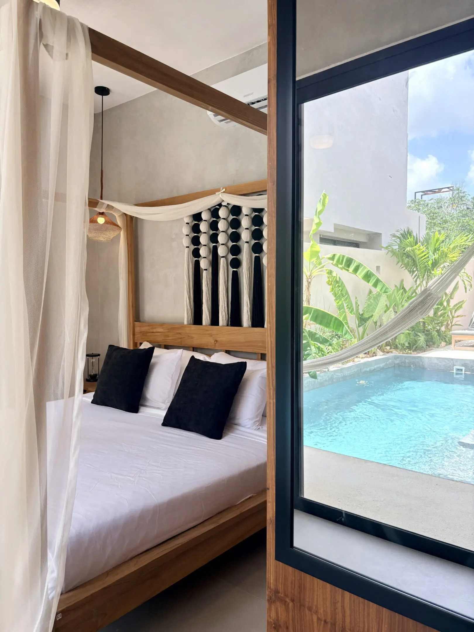 Canopy bedroom overlooking pool and hammock